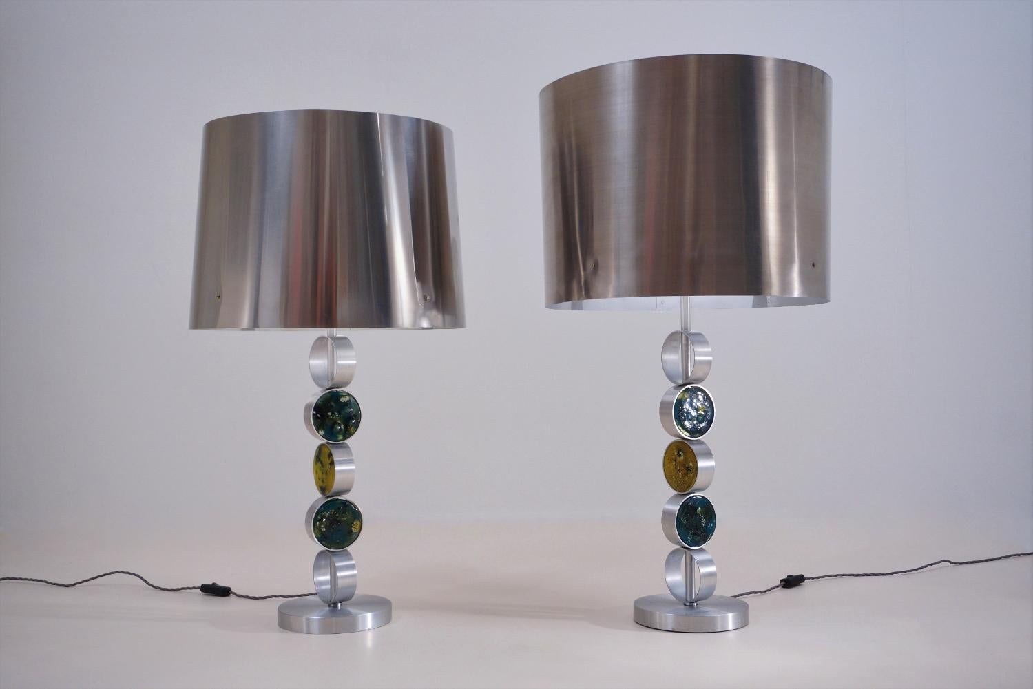 RAAK table lamps, large complementary pair, aluminium, steel and glass, 1972, Dutch. This is most likely a design by Nanny Still, one of the most famous designers at RAAK Amsterdam.

This pair of table lamps have been gently cleaned while