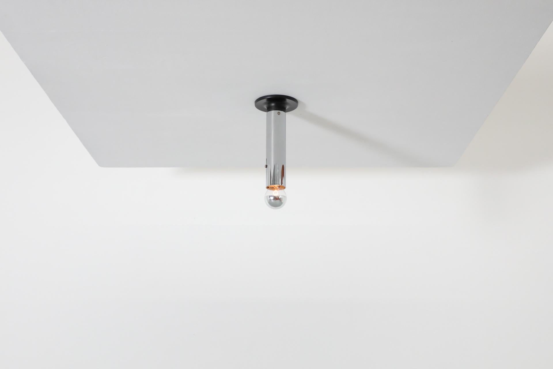 RAAK tall Maxibule chrome ceiling lights with chrome stem and black enameled metal base. In original condition with visible wear consistent with age and use. Shown with chrome tipped, medium base light bulbs. Small and medium sizes also available,