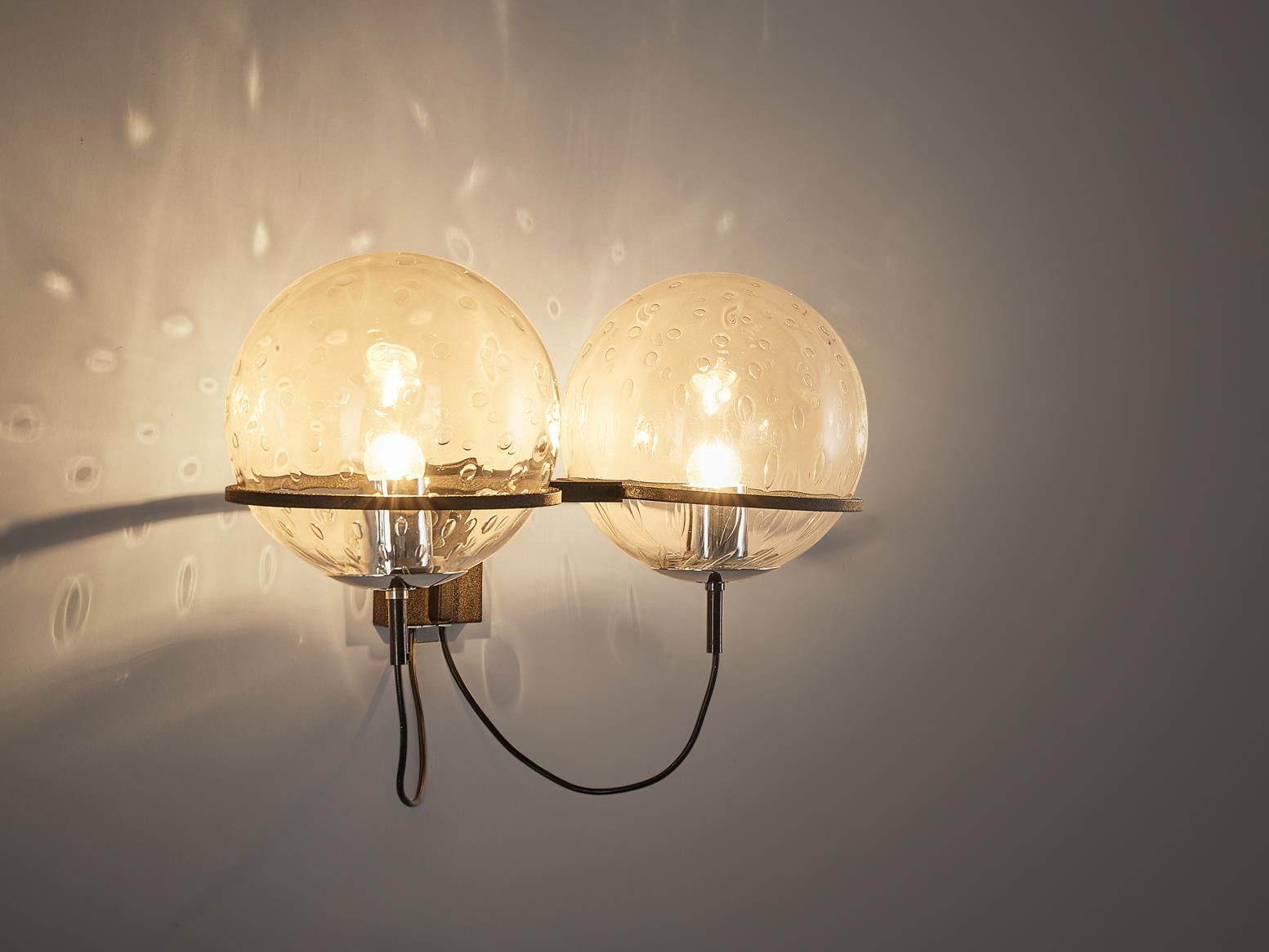 Raak wall light, chrome, glass, the Netherlands, 1970's.

Graceful wall light created by the Dutch manufacturer RAAK. Both lamps are equipped with two sphere glass bulbs. These are attached to a chrome plated wall-fixture by a chrome ring in which