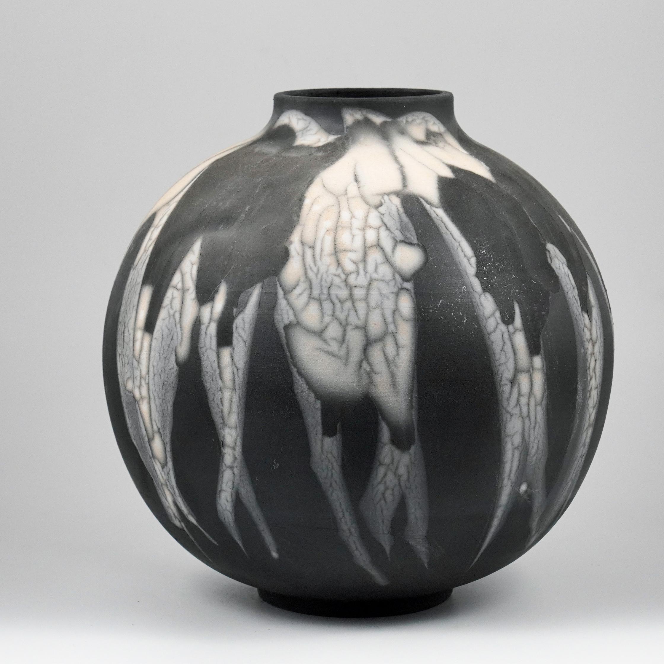 This Globe Vase is a round, capacious piece produced using the Raku technique, resulting in a beautiful unpredictable finish. This vase would be the perfect centerpiece or an addition to a growing collection of unique art in a home.

Smoked Raku is