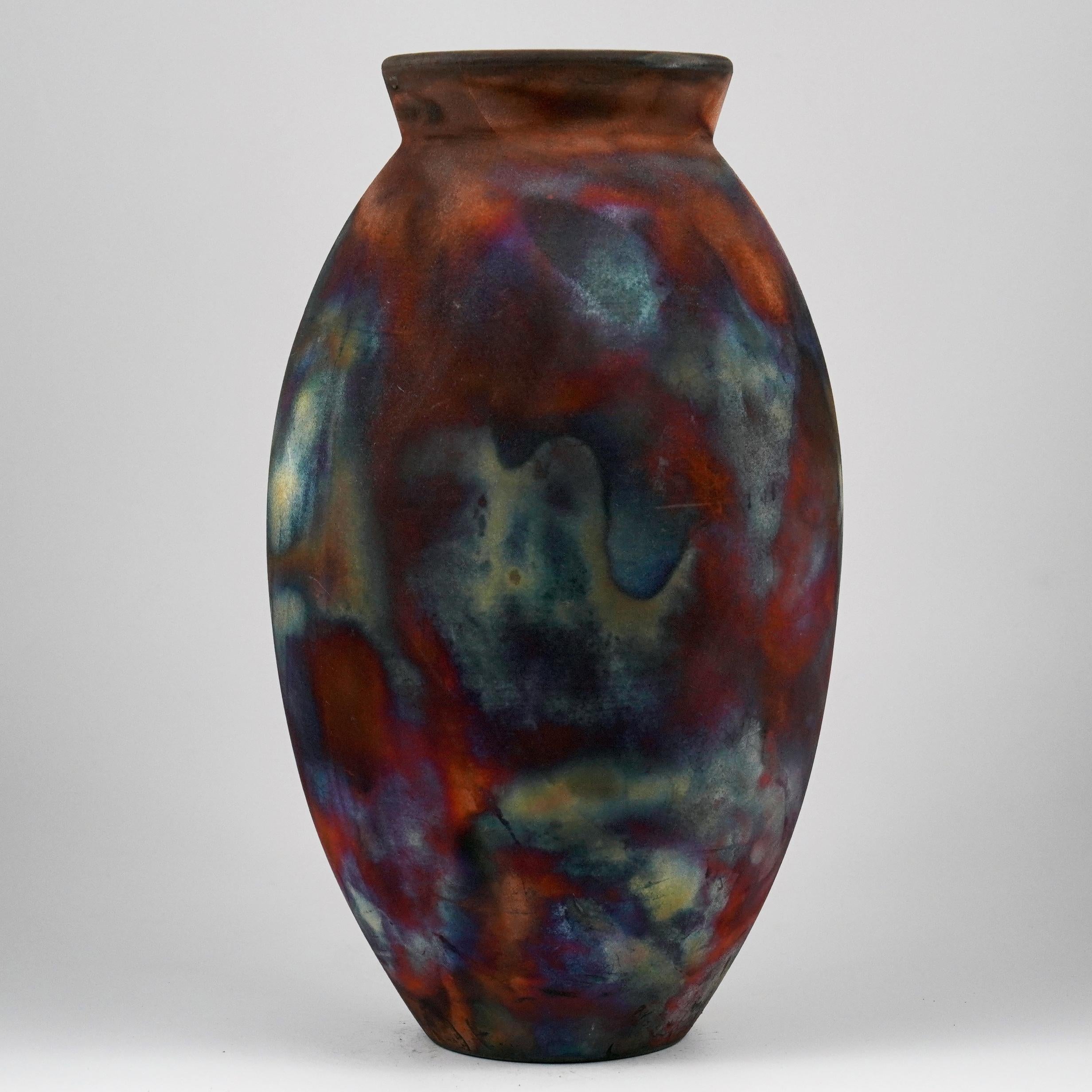 A mesmerizing sight to behold as soon as the rainbow-like patinas catch your eye. The Oval Vase is a tall, teardrop-shaped design best for adding a touch of elegance and intrigue to an interior space. Made using the Raku technique, it easily becomes