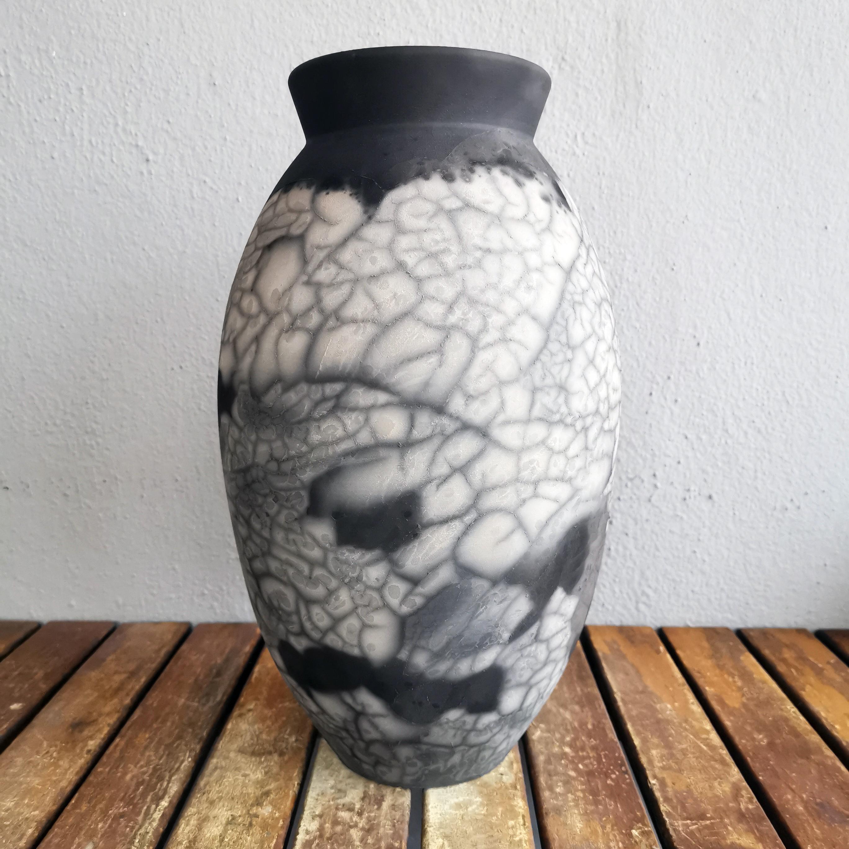 The Oval Vase is a tall, teardrop-shaped design best for adding a touch of elegance and intrigue to an interior space. Made using the Raku technique, it easily becomes a great conversation starter.
Smoked Raku is more commonly known as ‘Naked’ Raku