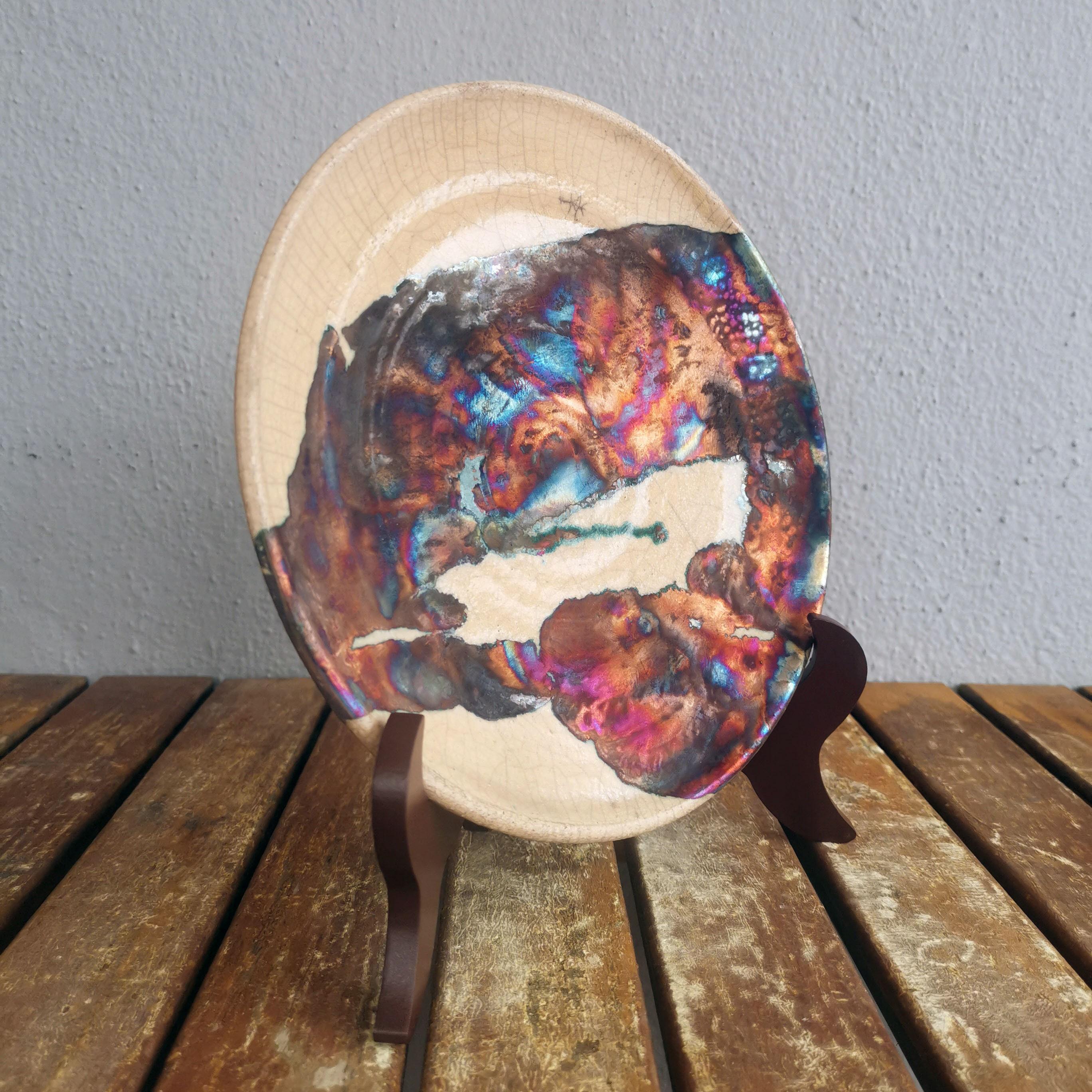 Sara ~ (皿) Plate

Our Sara decorative raku pottery plates are an expression of Raku in one of its most visible forms, a flat circular surface. Our Sara plates are best used hanging on your wall as a statement piece, a commemorative award, or as a