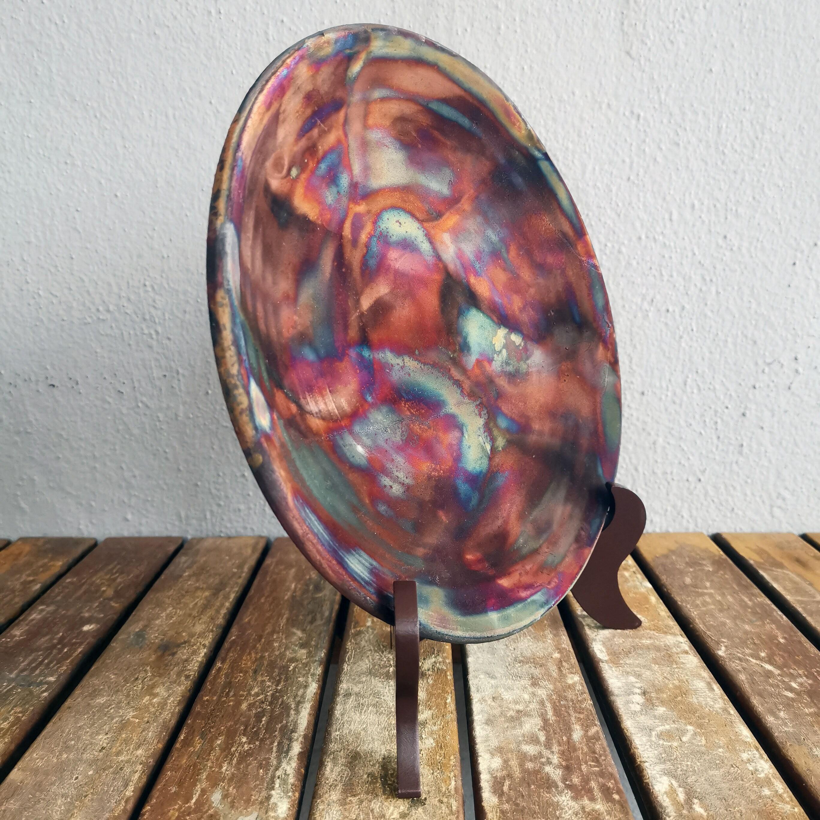 Sara ~ (皿) plate

Our Sara decorative raku pottery plates are an expression of Raku in one of its most visible forms, a flat circular surface. Our Sara plates are best used hanging on your wall as a statement piece, a commemorative award, or as a