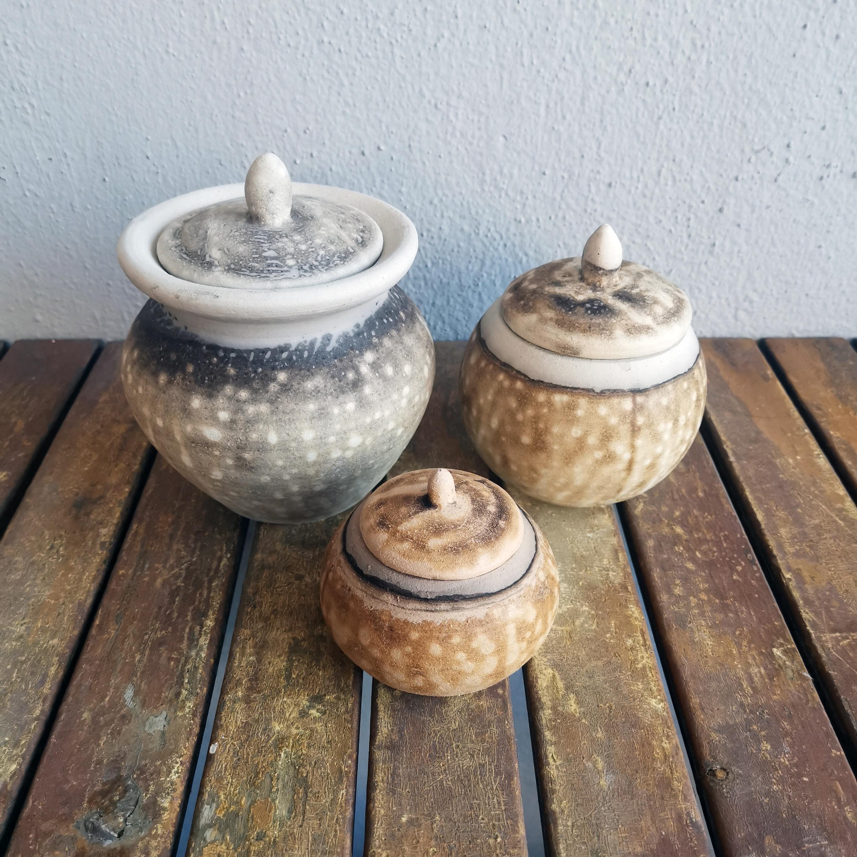 This is a set of 3 urns that are made of the following pieces :

*Heiwa - Peace*

Our Heiwa urn is a mid sized urn that has a unique lipped design where the lid goes into the body of the vase. This urn has a rounded knob cover holder and can be