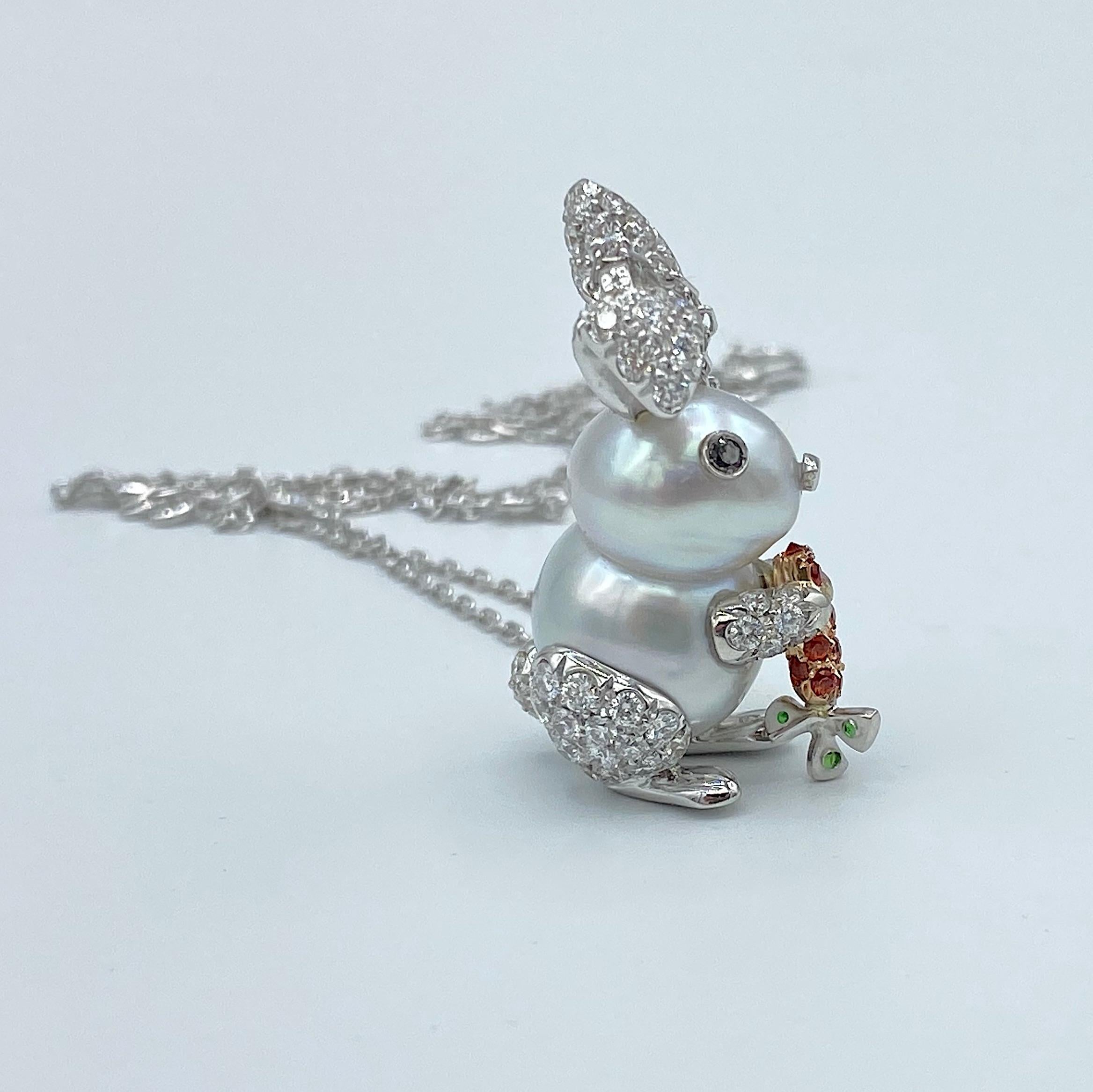 Rabbit White Black Diamond Sapphire Tsavorite 18Kt Gold Pendant Necklace 

I used a beautiful Australian baroque pearl, I made the legs, tail and ears in white gold by setting them with white diamonds to get a rabbit. Its front paws grab a red gold