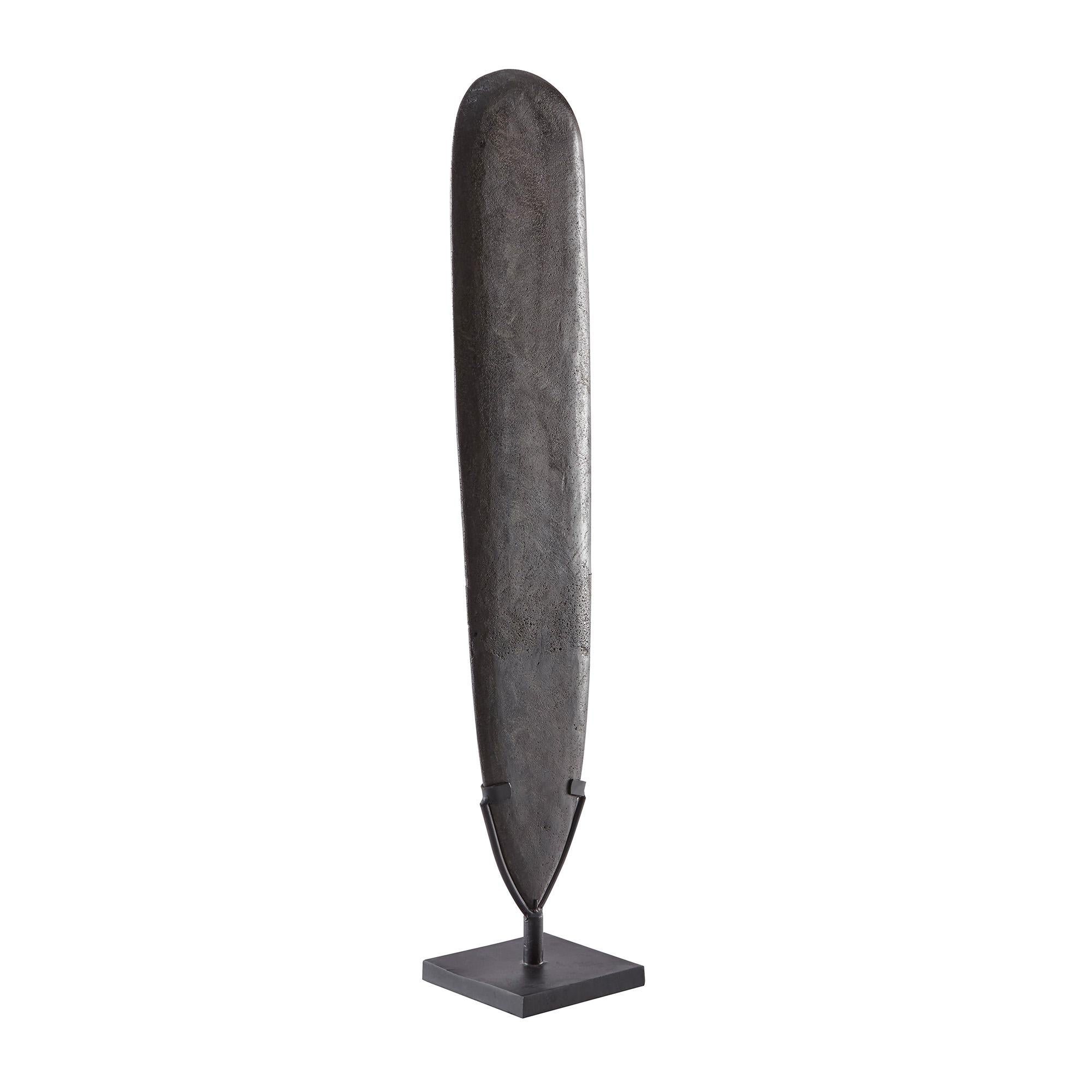 A monolith made of polished stone from Papua New Guinea mounted on a base.
 