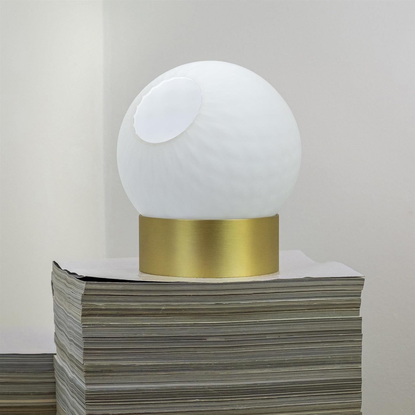 Reinventing a stunning Murano sphere from a discontinued collection by a renowned brand in the Brianza district, this sculptural vase belongs to a limited edition of 50 handcrafted pieces. The spherical recipient fashioned of opaline white Murano