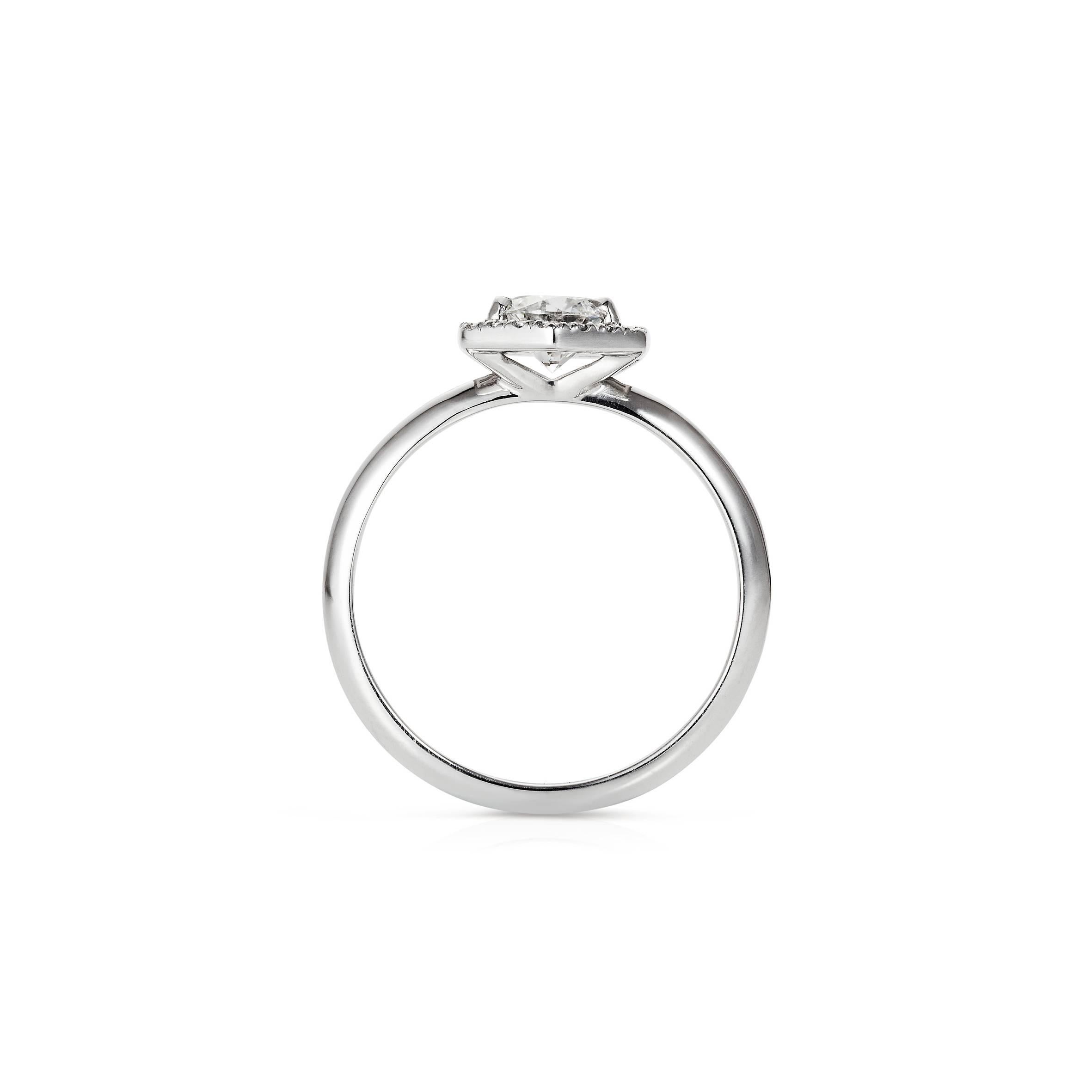 The 'Phoenix' Ring is a unique Engagement Ring designed by Rachel Boston and made in London, England. The central 0.50ct White Diamond has a surrounding microset diamond hexagon halo. The hexagon halo gives the engagement ring a modern sleek look