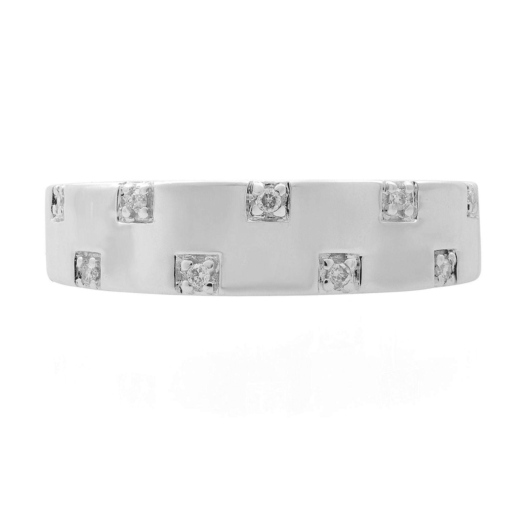 This elegant and classic diamond wedding band ring is crafted in 18k white gold. Features tiny pave set 9 round brilliant cut diamonds with a total carat weight of 0.05. Diamond color H and I clarity. Ring width: 5 mm. Ring size: 7. Total weight: