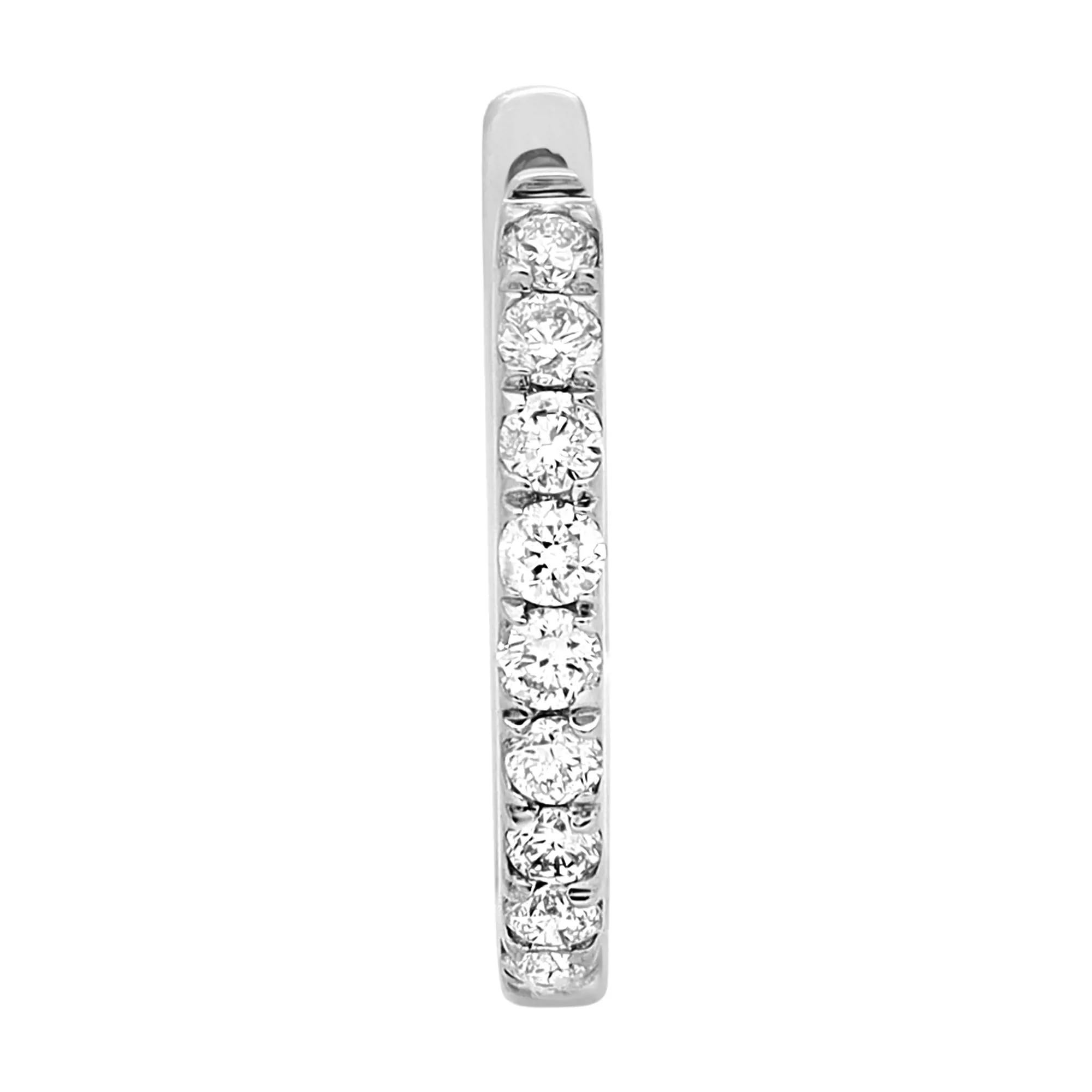 Sleek and classic, these timeless diamond huggie earrings are perfect for a great everyday look. Featuring a row of prong set bright white round cut diamonds set in lustrous 14K white gold. Total diamond weight: 0.20 carat. Diamond quality: Color