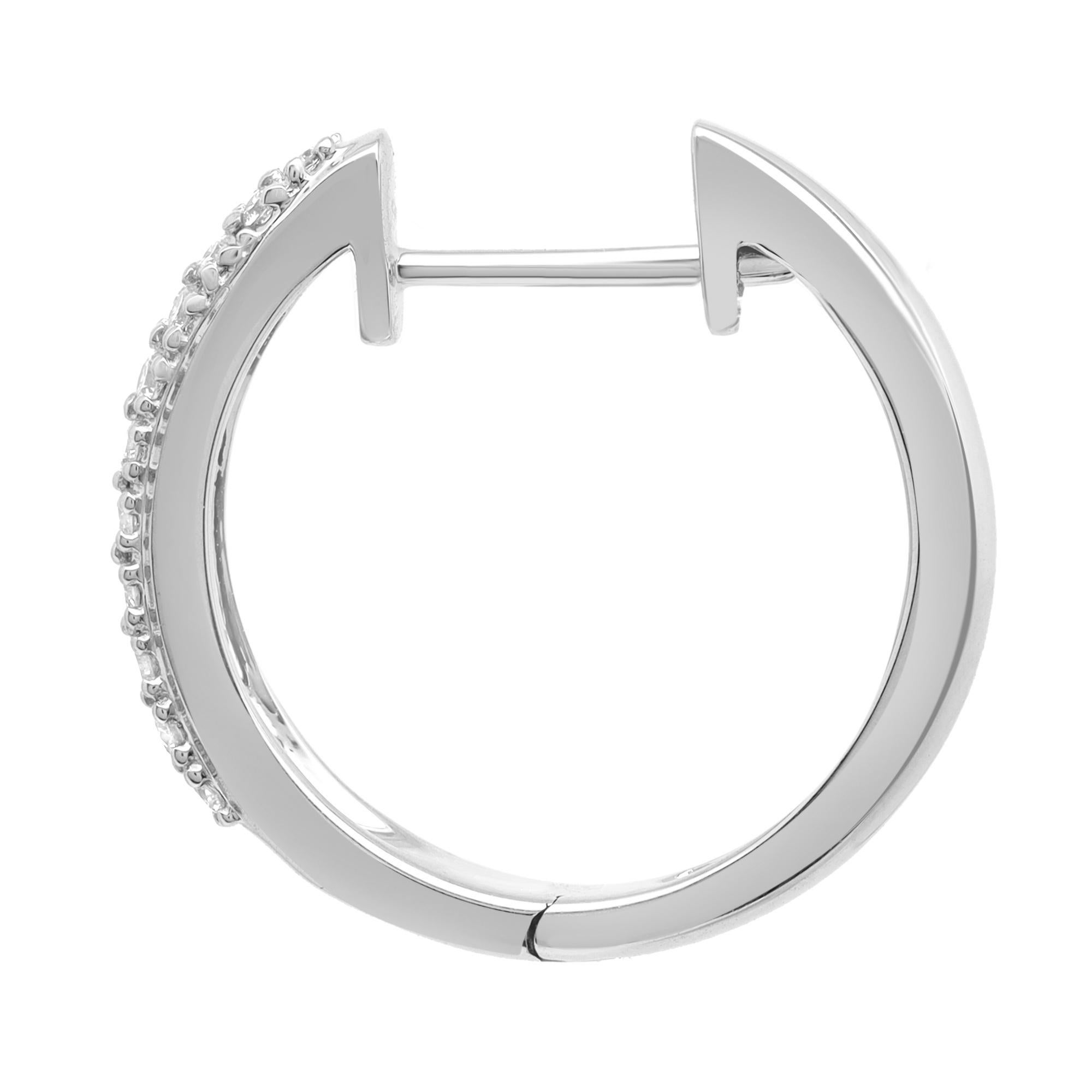 Sleek and classic, a timeless pair of diamond huggie hoop earrings. These earrings are crafted in 18K white gold and encrusted with prong set round cut diamonds weighing 0.41 carat. Diamond color G-H and clarity VS-SI. Secured with hinged back.
