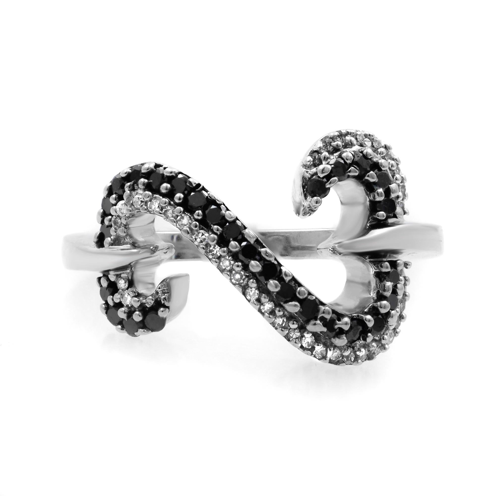This stylish ring features prong set white and black diamonds encrusted in an open heart shaped mounting. Crafted in 14k white gold. Total diamond weight: 0.50 carat. Ring size: 6.75. Total weight: 4.79. Great pre-owned condition. Comes with a