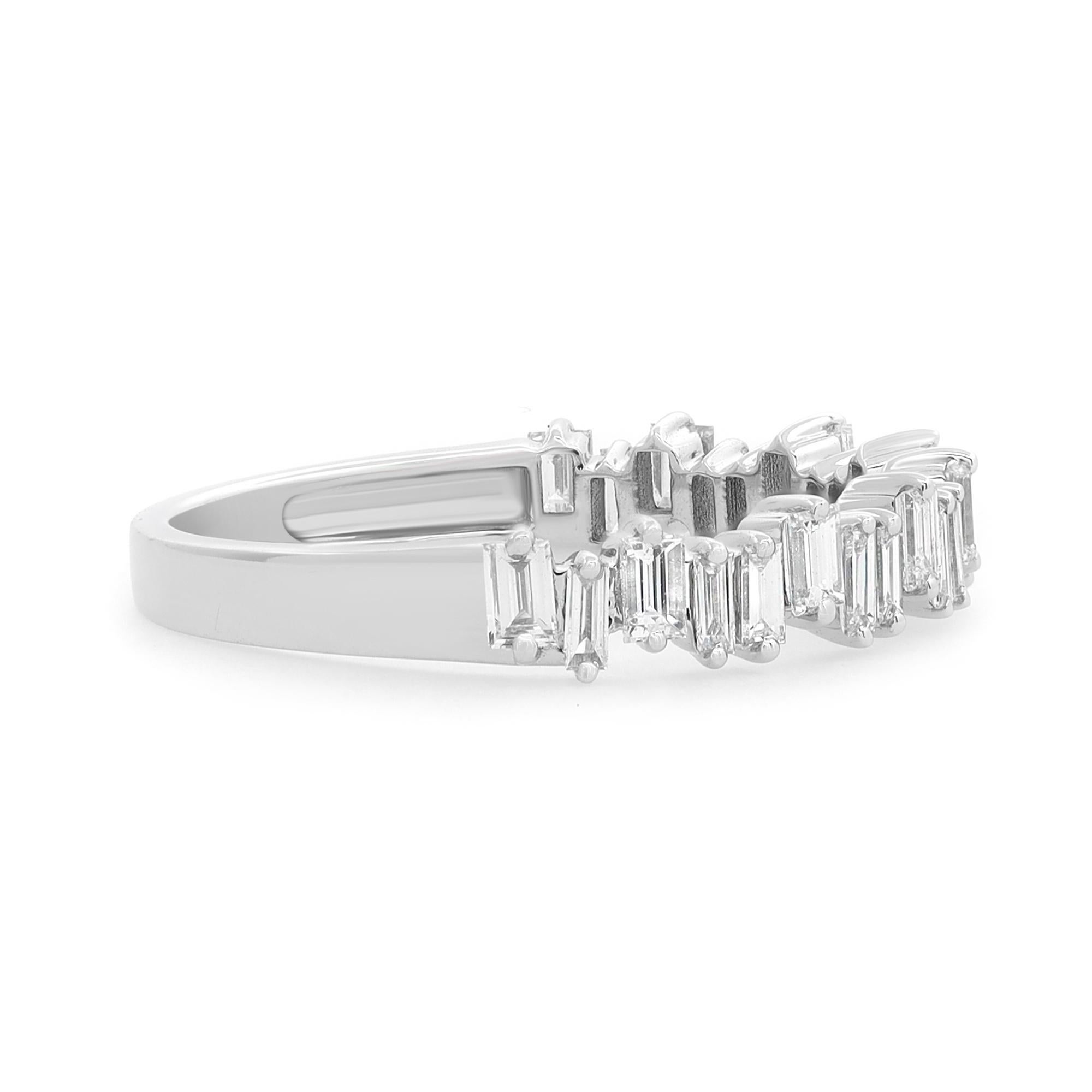 Simple and delicate diamond ring crafted in 18k white gold. This ring features prong set baguette cut diamonds set in a zig-zag pattern portraying a timeless, eye-catching style. It's stackable and easy to mix and match. Diamond carat weight: 0.63.