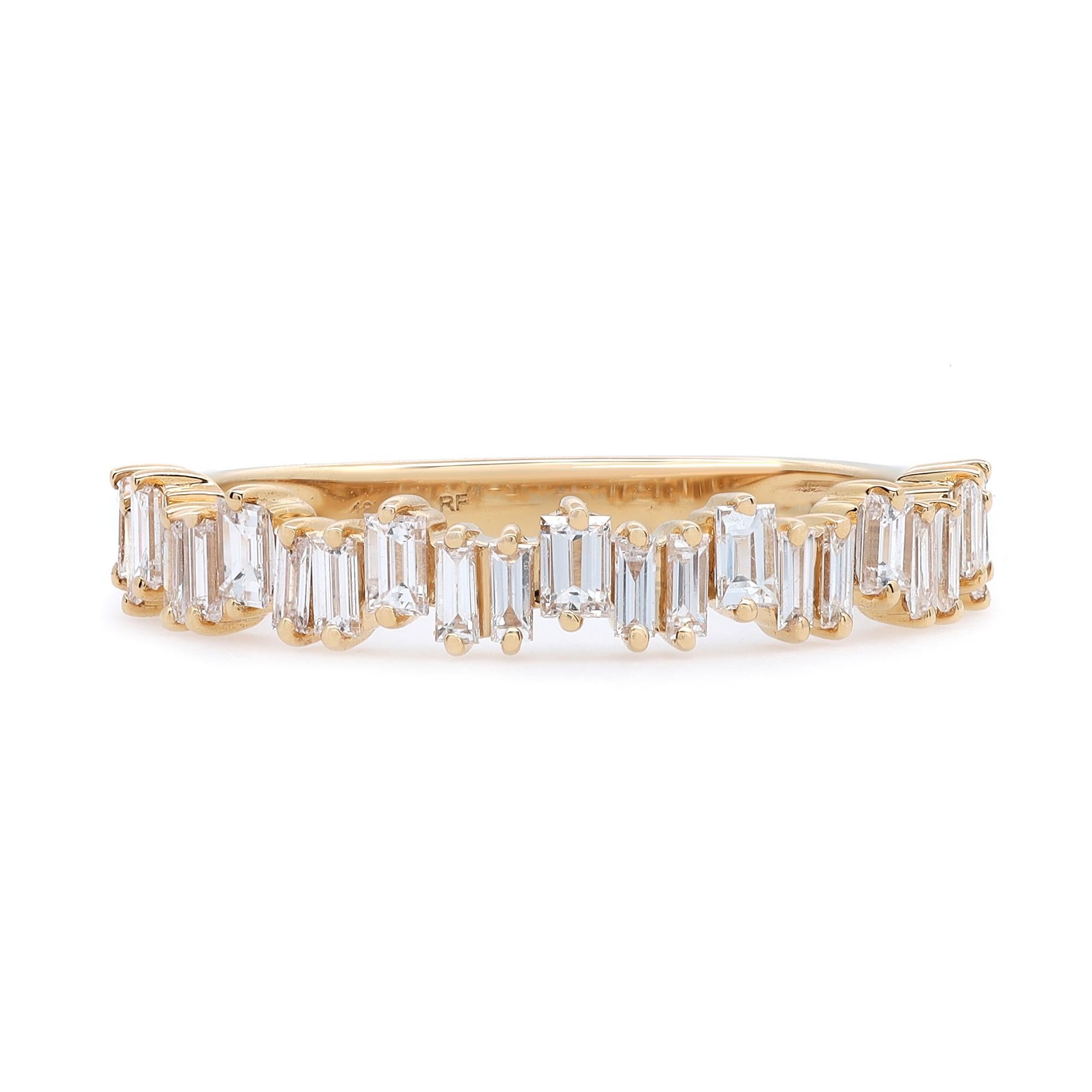 Simple and delicate diamond ring crafted in 18k yellow gold. This ring features prong set baguette cut diamonds set in a zig-zag pattern portraying a timeless, eye-catching style. It's stackable and easy to mix and match. Diamond carat weight: 0.64.
