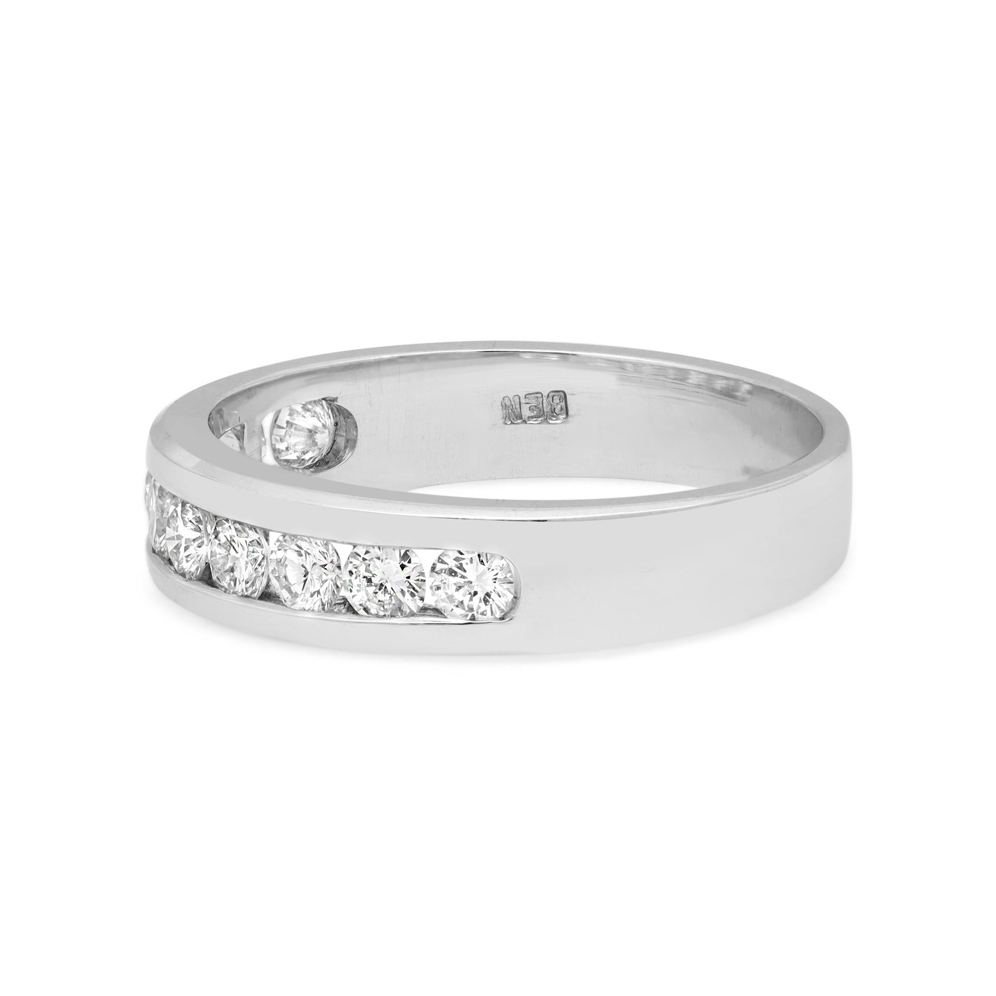 This classic women's band ring features 10 round brilliant cut dazzling natural diamonds. All diamonds are channel set in a solid platinum setting. Total carat weight: 0.75. Diamond color G and SI1 clarity. Band width: 4.7 mm. Ring Size 7. Total