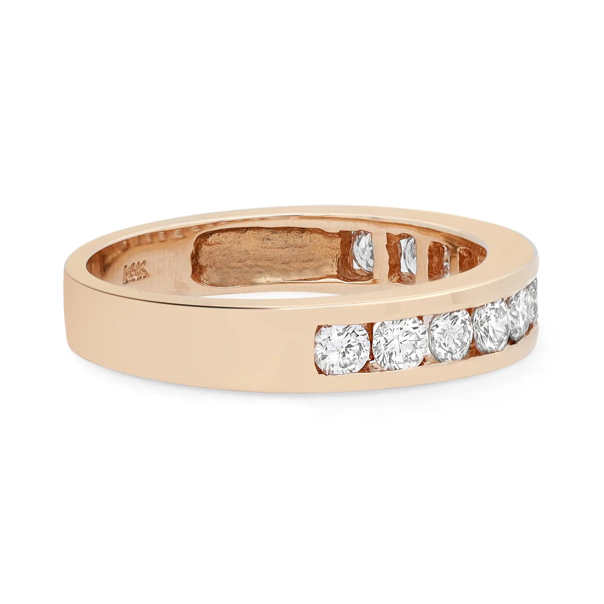 This classic women's band ring features 11 round brilliant cut dazzling diamonds. All diamonds are channel set in a high polished 14K yellow gold setting. Total diamond weight: 0.75 carat. Diamond color H and VS1 clarity. Band width: 4 mm. Ring Size