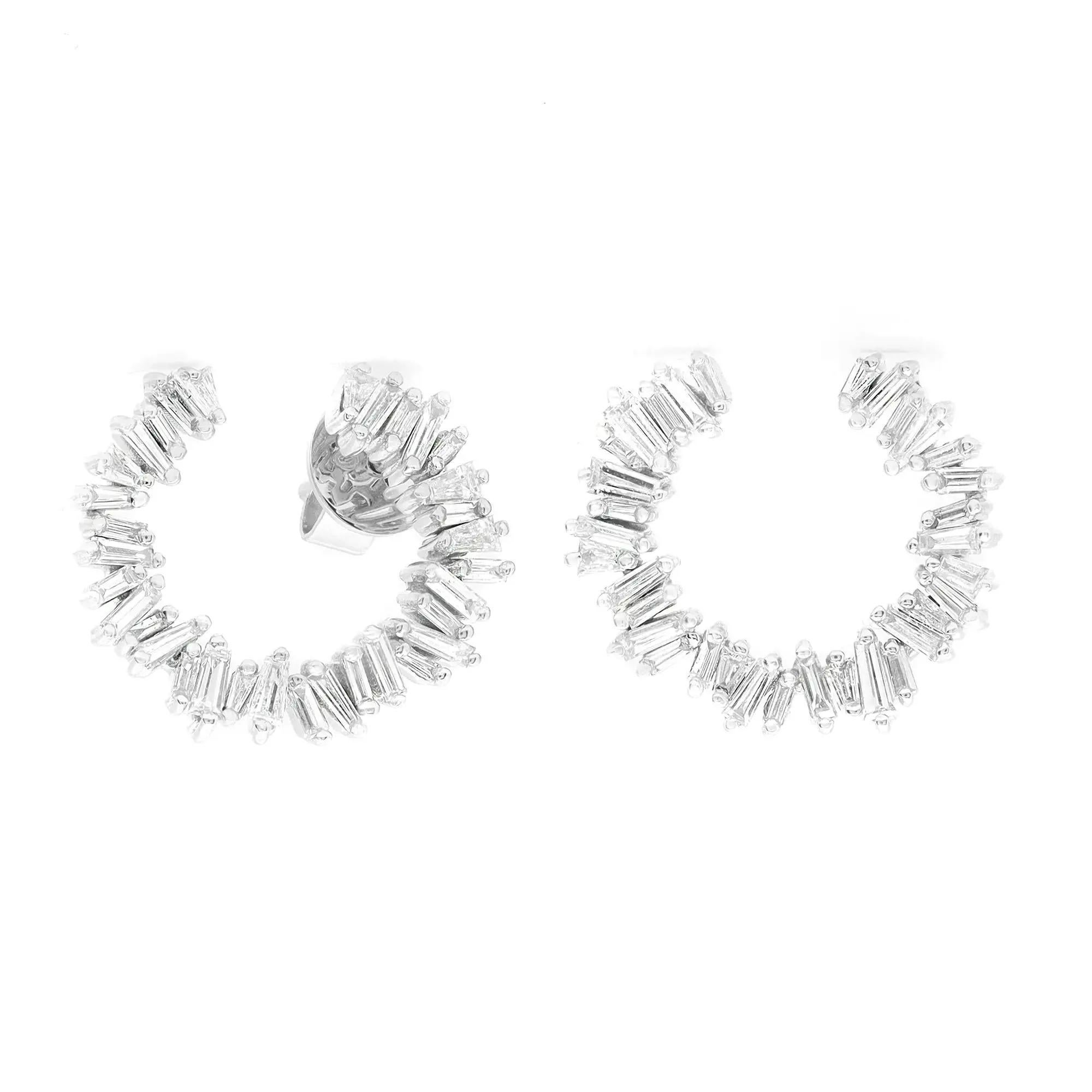 Elevate your attire with these dazzling diamond stud earrings. Crafted in fine 18K white gold. These earrings feature prong set baguette cut diamonds set in a C-shaped shank. Total diamond weight: 0.95 carat. Diamond quality: color G-H and clarity