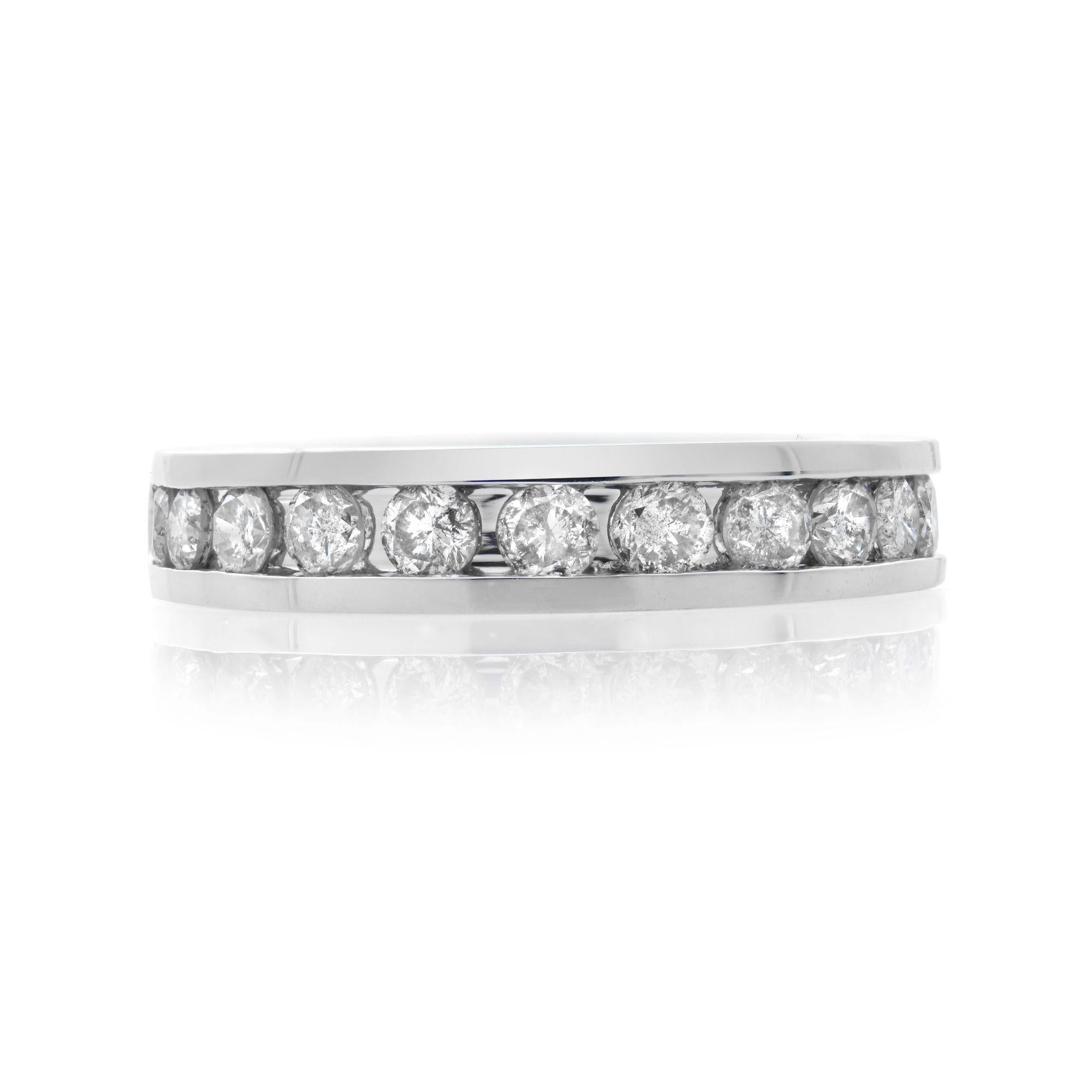 Elegant and classic diamond wedding band ring. Crafted in 14k white gold. It features a sparkling row of channel set 14 round brilliant cut diamonds weighing 1.00 carat. Diamond color G-H and SI clarity. Ring width: 4.13 mm. Ring size 6.75. Total