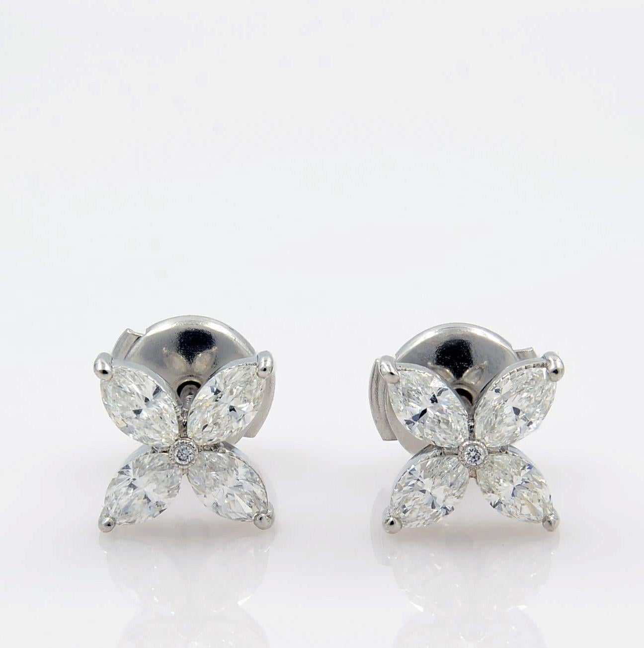 Lovely marquise cut diamond stud earrings set in highly secure designer style platinum mounting. These feminine and super wearable platinum cluster stud earrings are absolutely handmade and a great addition to your jewelry collection. Each earring