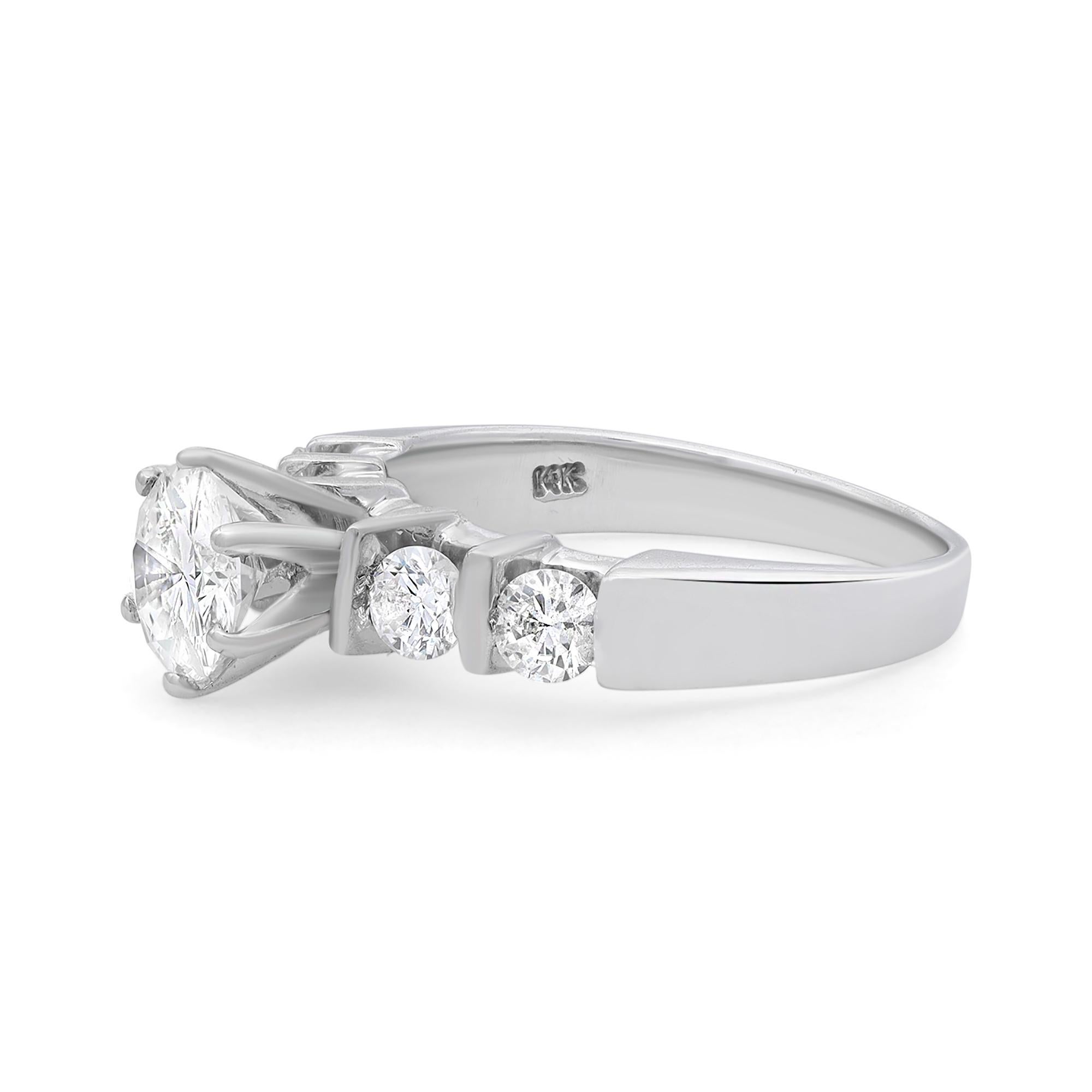 Stunning ladies diamond engagement ring crafted in 14k white gold. This beautiful ring features 0.85 carat of prong set round brilliant cut center diamond with round cut side diamonds weighing 0.50 carat. Total diamond weight: 1.35 carats. Diamond