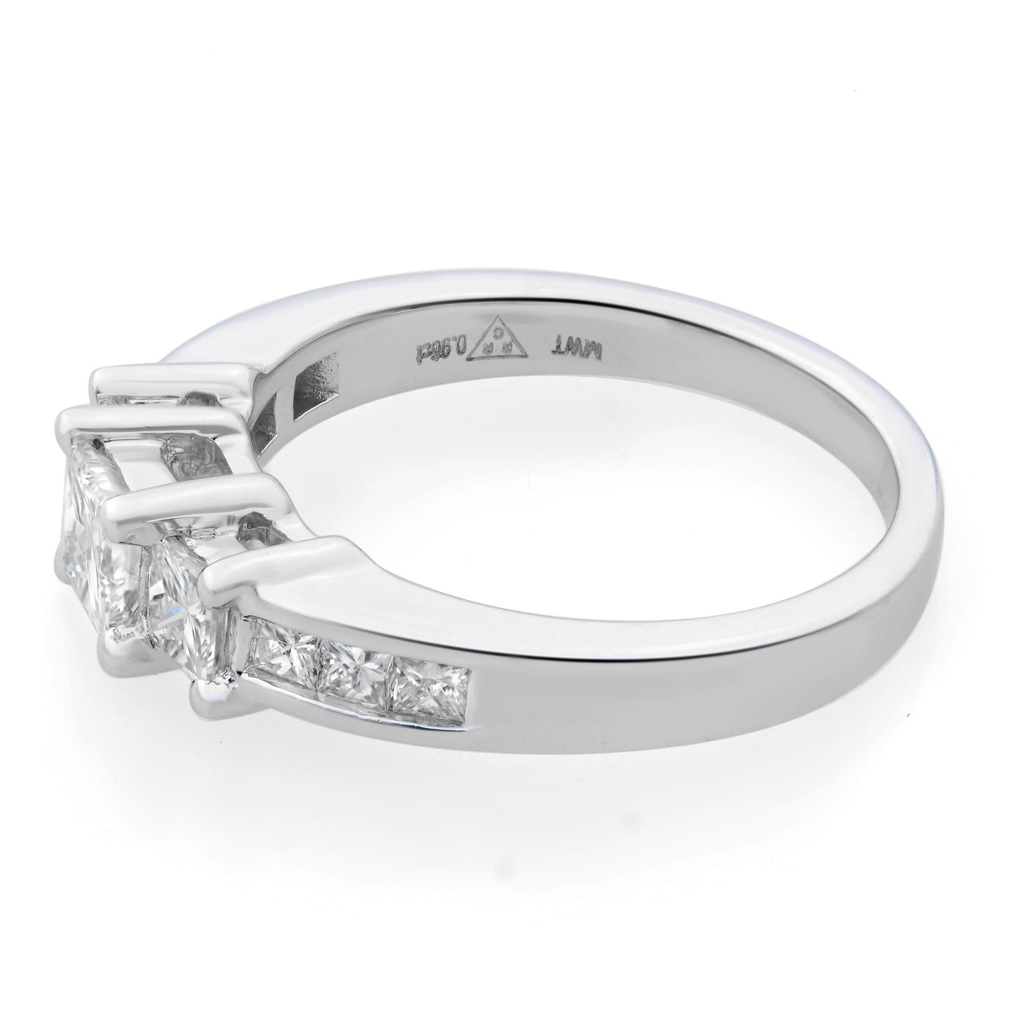 Our three-stone engagement ring features a 0.50 carat princess cut diamond center stone which is accented by two princess cut diamond side stones. More princess cut diamonds are channel set along the shank. This 14K white gold engagement ring has a