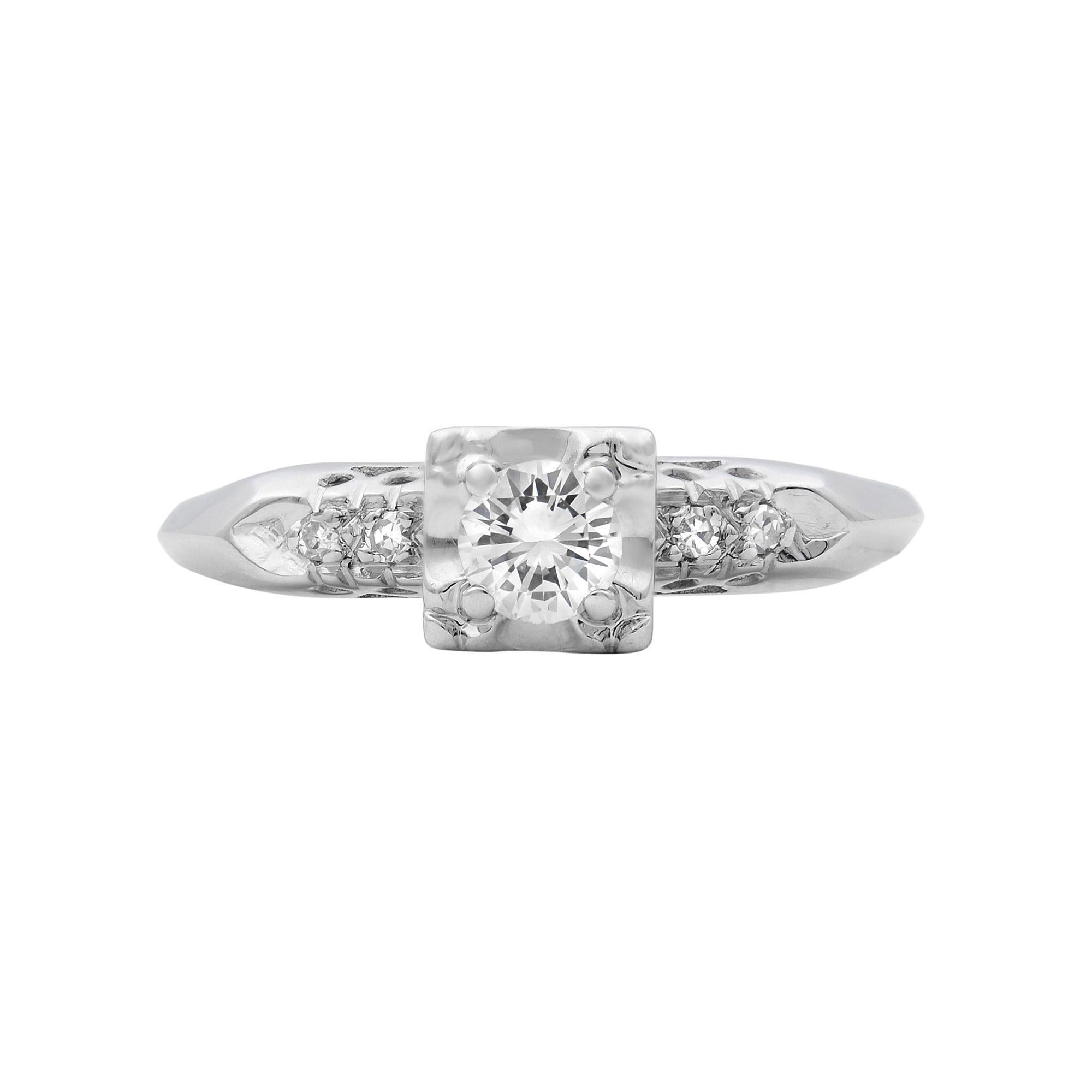 This stunning unique style engagement ring holds a small 0.20 carat center stone. Crafted in 14k white gold. This is an old style design. Looks very delicate. Total carat weight: 0.25. Diamond color G and VS2 clarity. Ring size 7.5. Comes in a