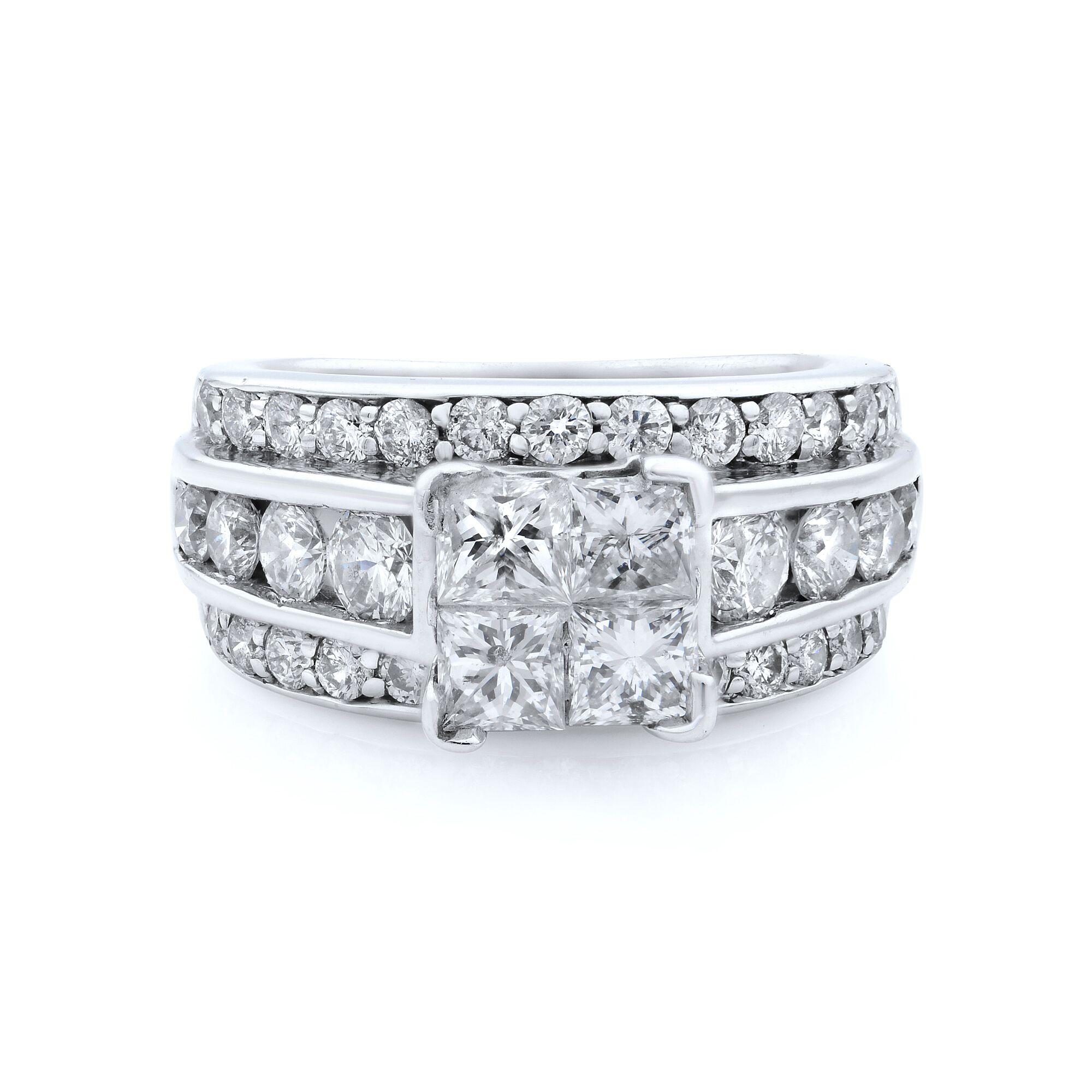 This unique engagement ring has a delicate four princess cut stones at a center, set with 14k white gold. The shank of this engagement ring  is set with round cut diamonds, spited into three line prong settings on the sides and a channel set in the