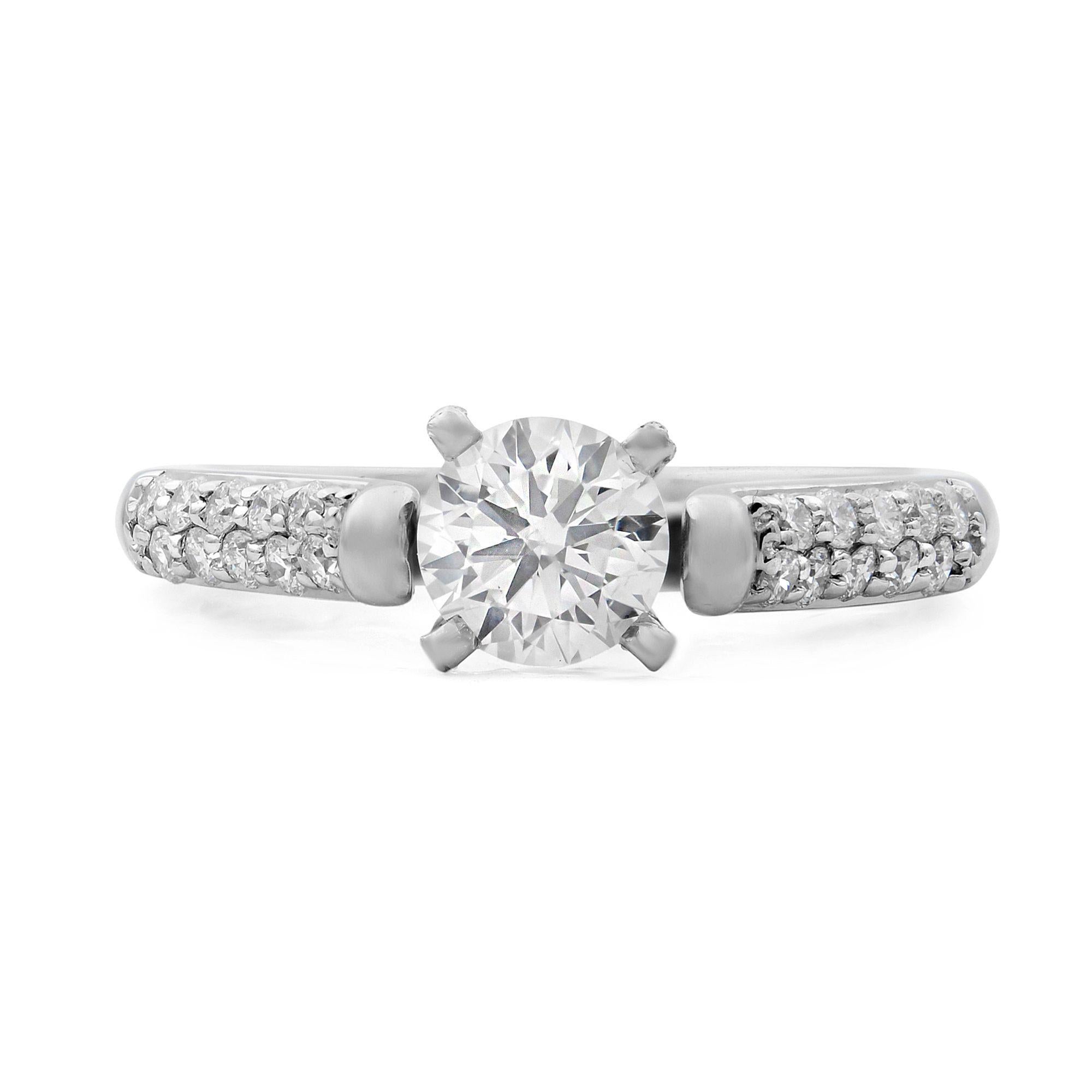 This is an elegant 14k white gold diamond engagement ring. A round-cut diamond center stone serves as the focal point, while diamond accents adorn the band with eye-catching sparkle. Center stone 0.50. Total carat weight of the ring 0.75. Ring size