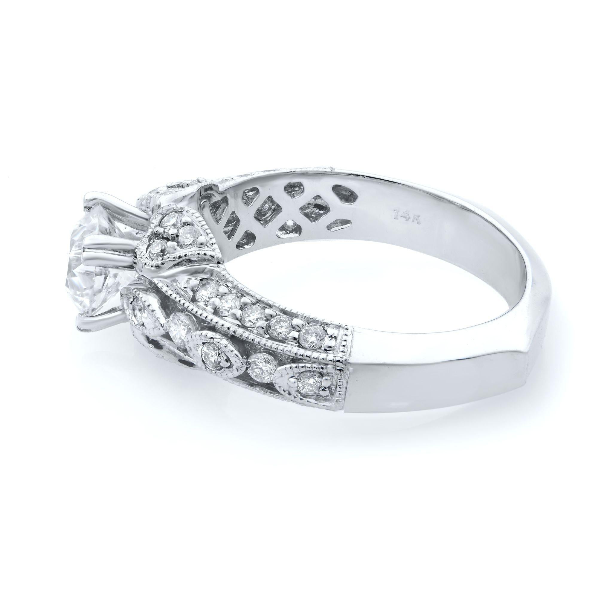Design of this engagement ring is a dazzling sight with a 1.00 carat round cut center stone. Diamonds graduate in size along its band and encircle the entire ring. Elegant hand-formed filigree is featured on its profile and its interior. Mill-grain