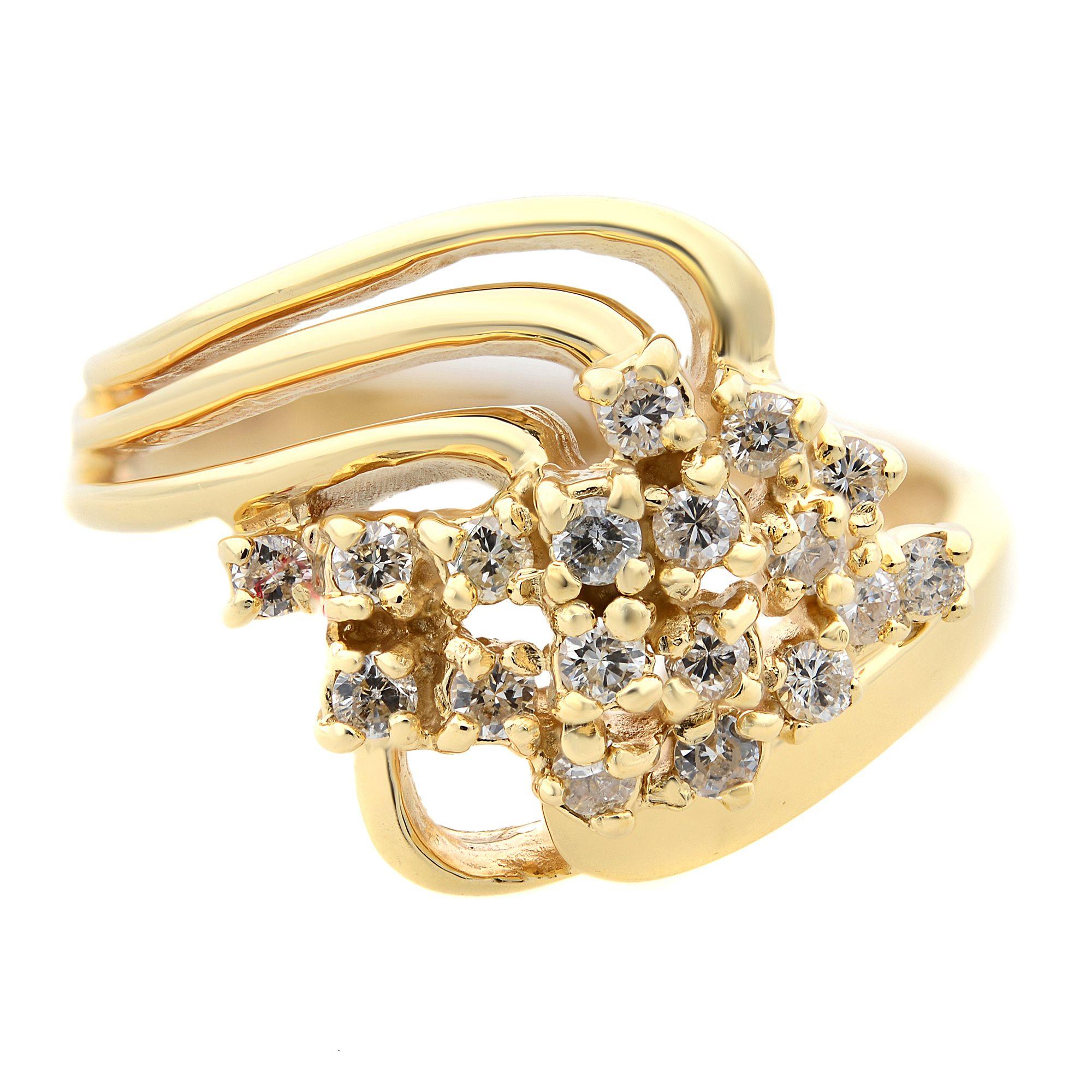 Shimmering round cut diamonds are the focal point of this dazzling ladies diamond cocktail right hand ring. This ring is crafted in solid 14 karat yellow gold. It features a cluster of prong set round diamonds on a bypass setting. If you are in the
