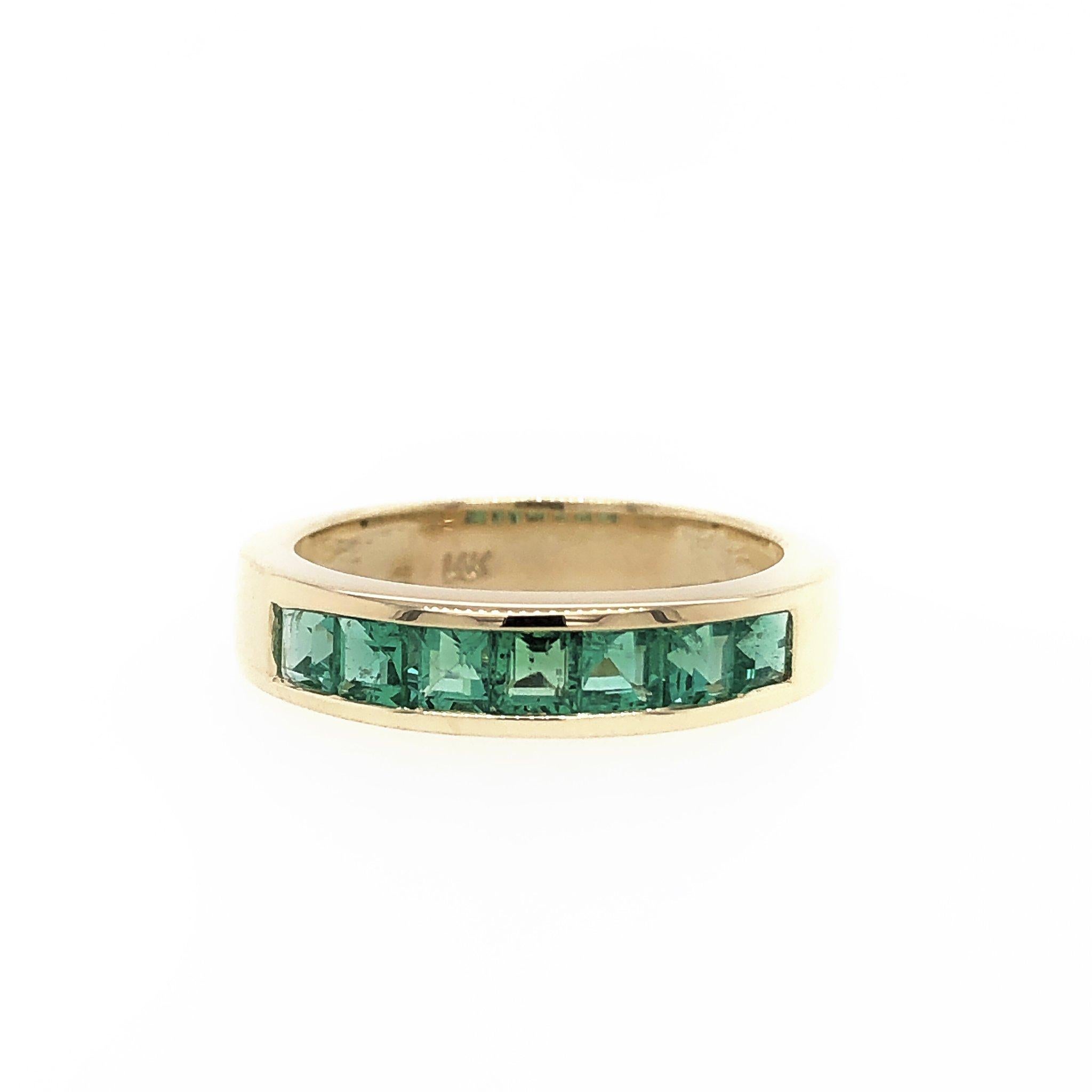 Clean and simple, this gorgeous channel set band ring is channel set with 7 green Emeralds which been carefully hand matched. Total carat weight: aprox. 0.81. Width of the ring is 4.23mm. Crafted in 14k yellow gold. Ring size 6. Weight: 4.30 grams.