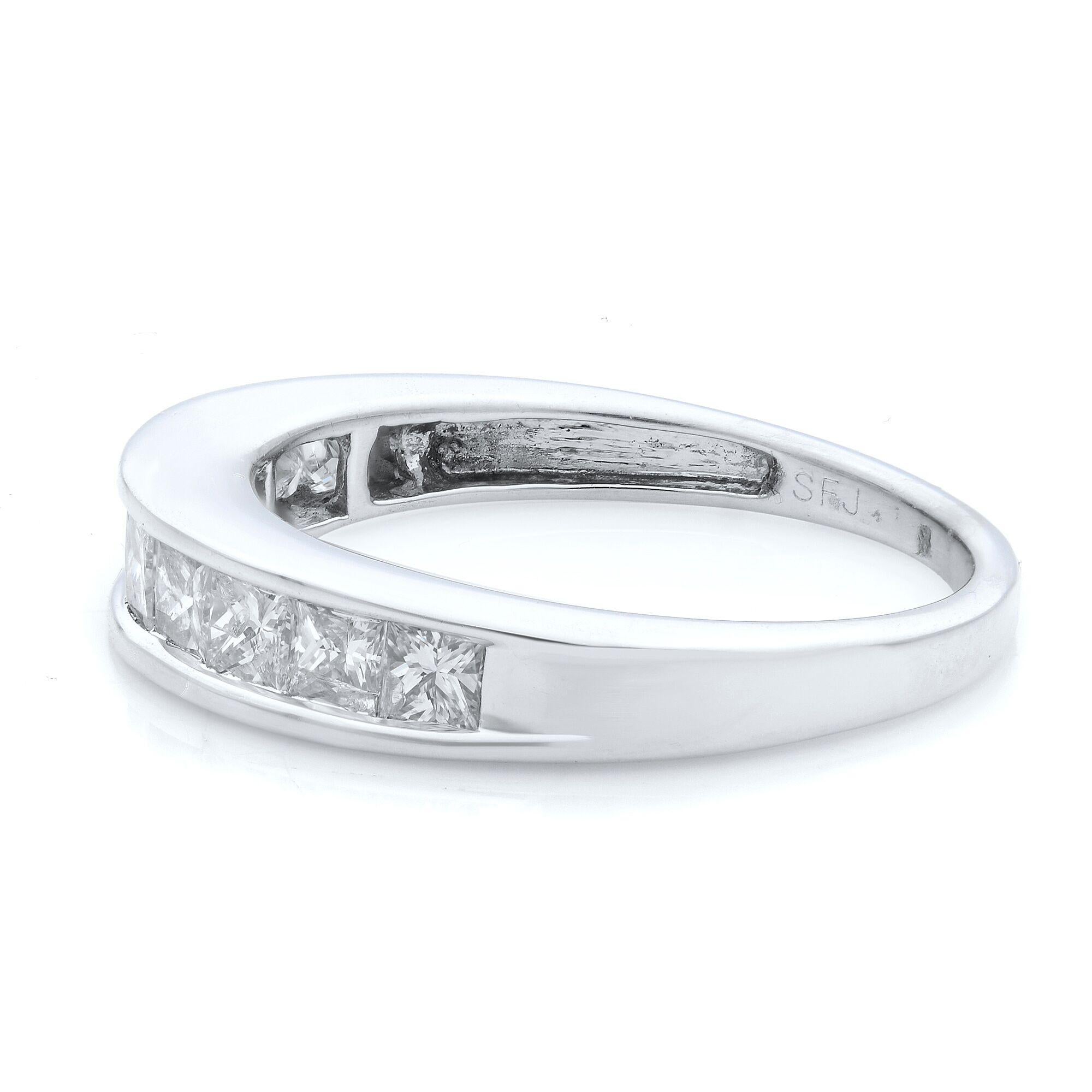 This classic 14k white gold wedding band is channel set half way around with 10 princess cut diamonds. Total carat weight is approximately 1.00 carat. The diamonds grade is J color and SI1 in clarity. Ring size 7.25. Comes in our presentation box.