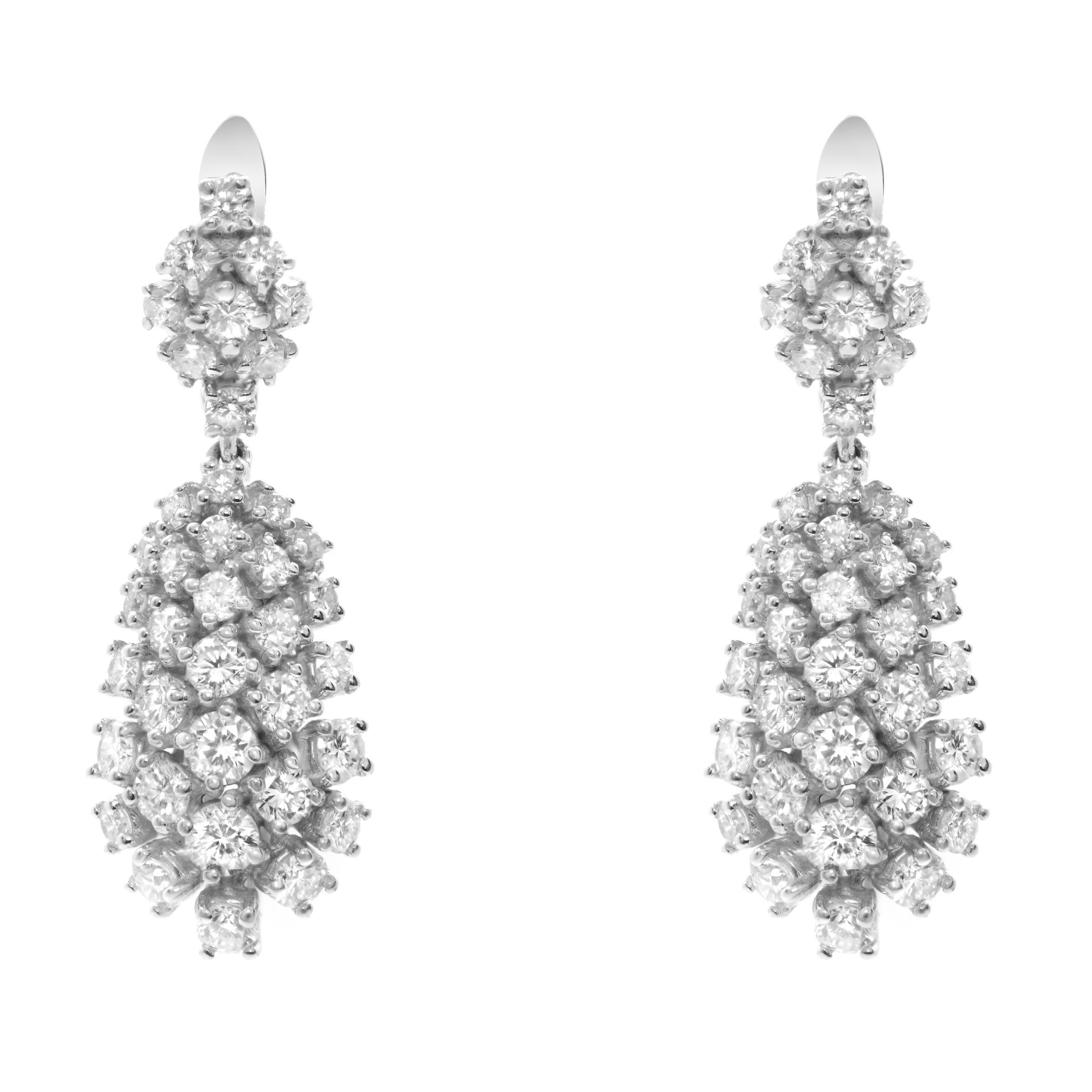 Classic 14k white gold 4.32cttw diamond drop earrings featuring brilliant round diamonds in stunning yet sophisticated 4-prong settings that dangle from an eye-catching diamond lever-back post. Each diamond in this luxurious pair of earrings are