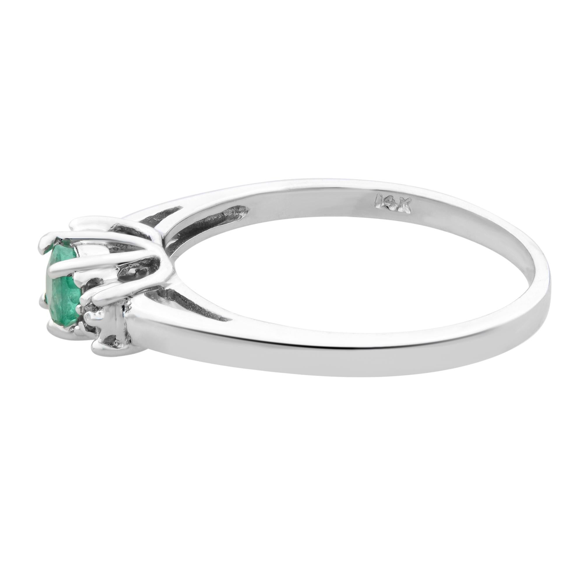 This beautiful ladies cocktail ring is unworn and comes with manufacturers box and booklet. Made with 14K White gold, it features a 0.25cttw round cut emerald and accented with diamonds of 0.02cttw, all gemstones set with prongs.