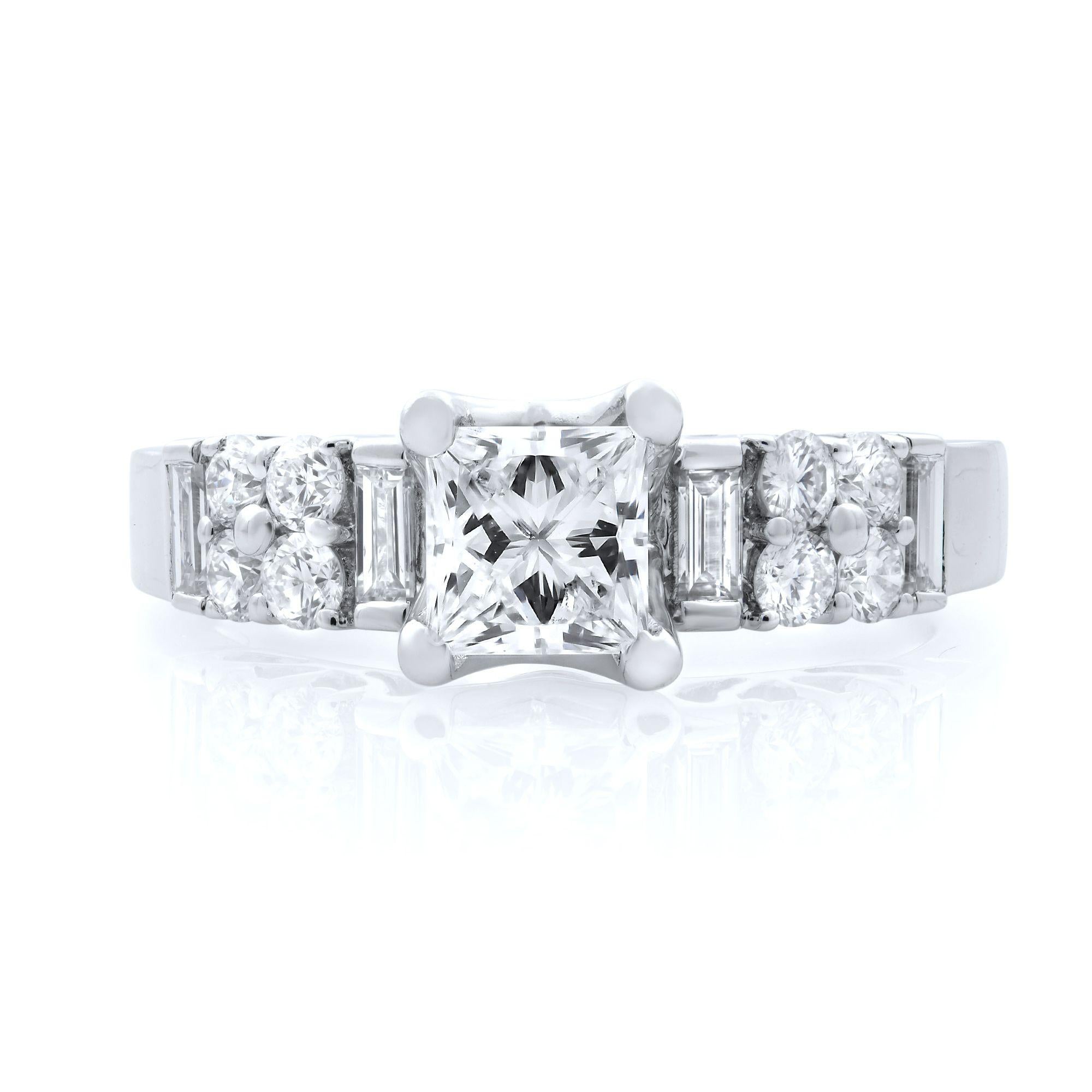 Stunning women’s princess cut diamond engagement ring crafted in 18k white gold. This beautiful ring features 0.50 carat of princess cut center diamond with round and baguette shaped side diamonds. Total diamond weight: 1.50 carats. Diamond Color: