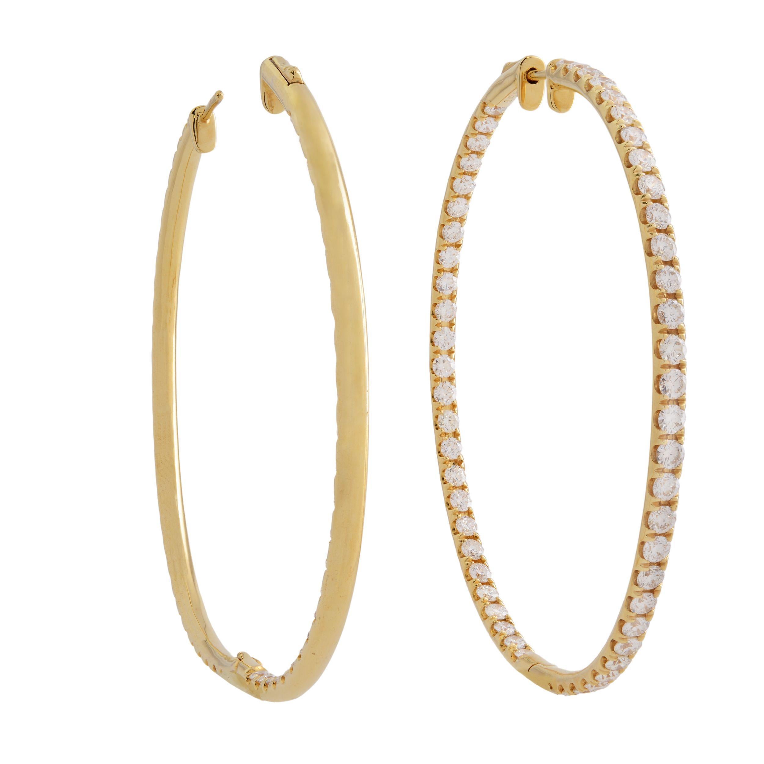 A very beautiful pair of Estate inside-out diamond hoop earrings. Each earring is crafted in 18K yellow gold which are lined with sparkling round cut pave set diamonds. The stones line only half of the outer hoop and half of the inner hoop. Total