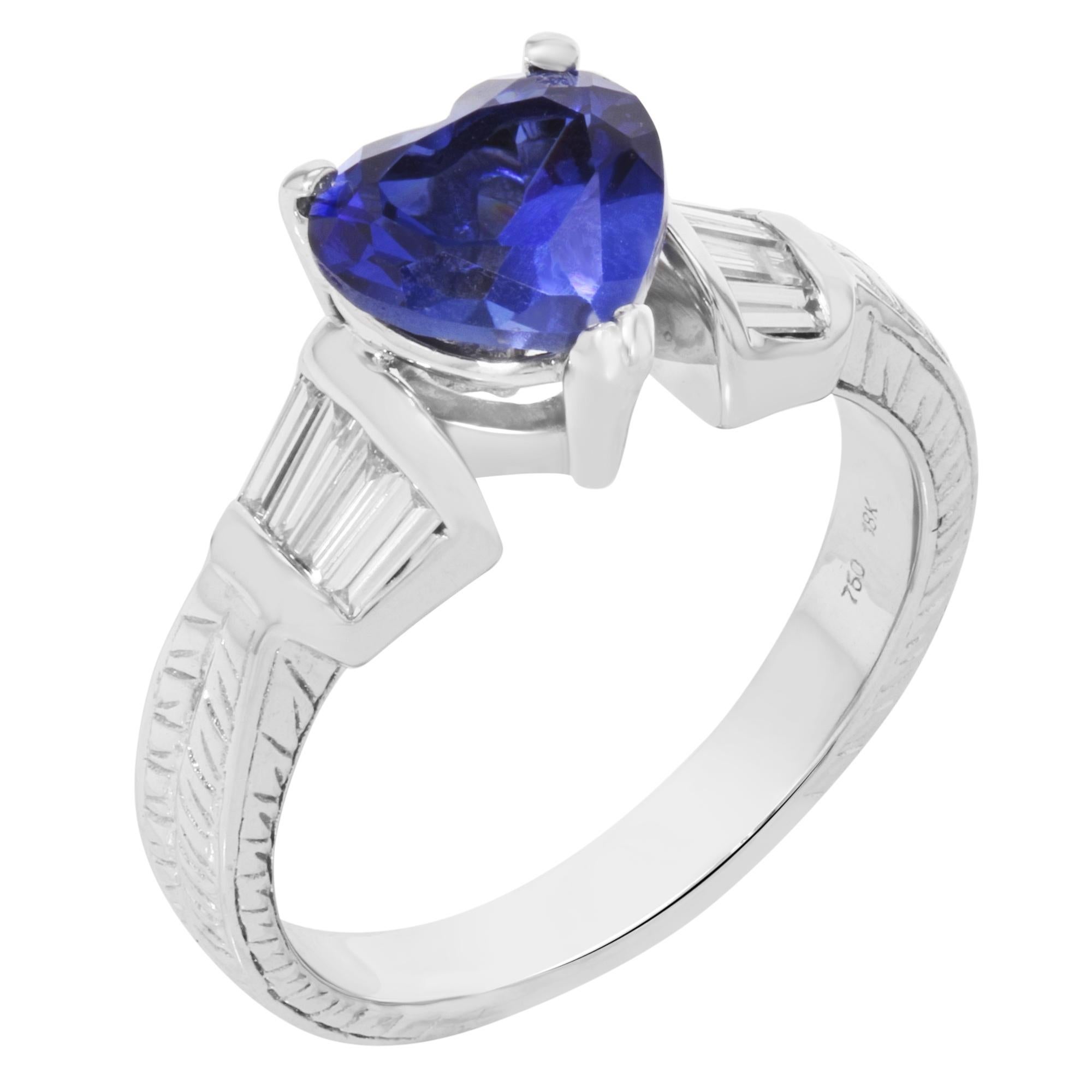 This stunning women's ring is crafted in 18K white gold with approximately 1.25 carats of heart-shaped blue sapphire and 0.30 carat of baguette cut diamonds. Ring size: 6.5. Total weight: 6.4 grams. Comes in a presentable gift box. 