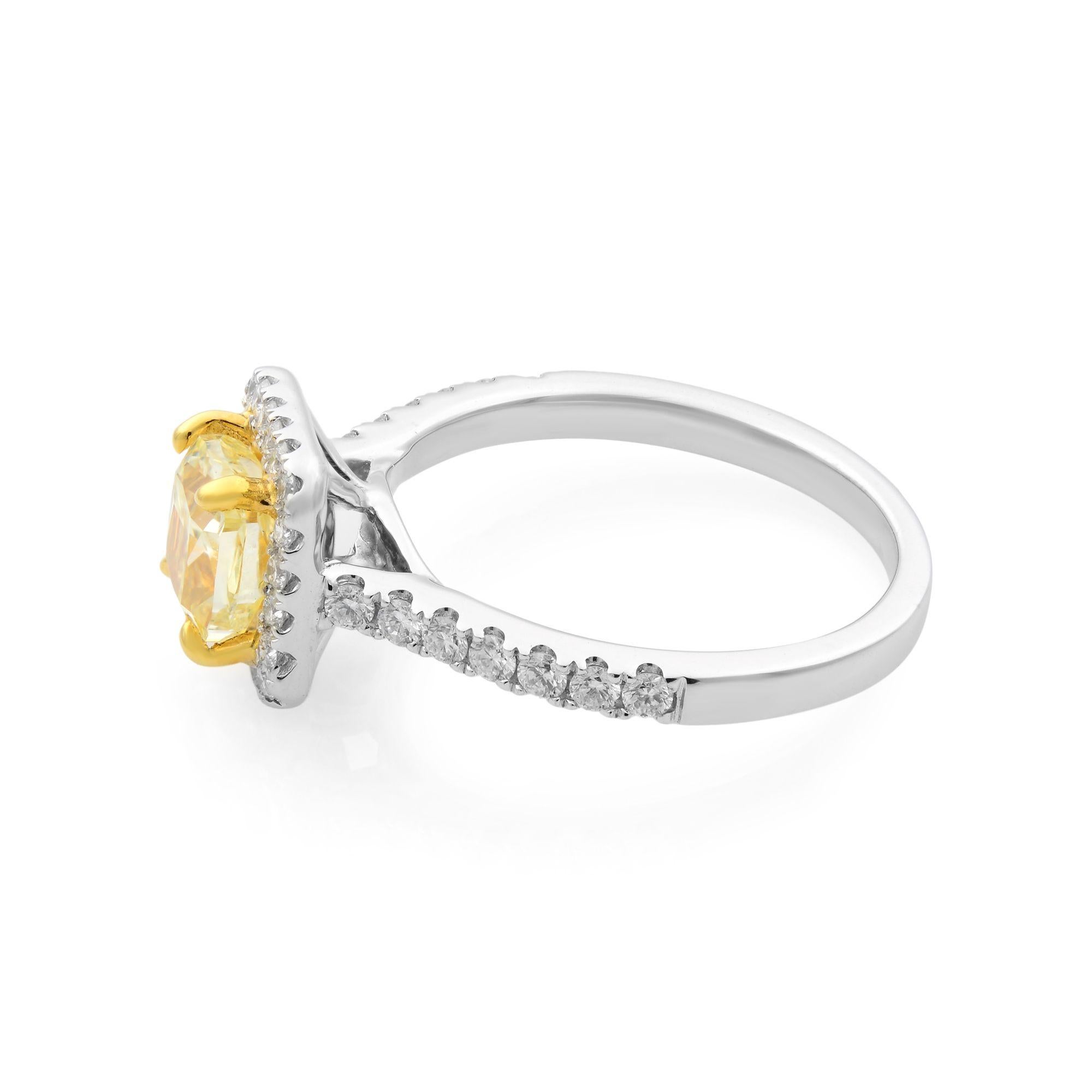 This cushion cut diamond is a vivid fancy yellow that radiates bright light and sparkles like the sun. The center stone is surrounded by a halo of prong set white diamonds, the elongated cushion cut stone is accented exquisitely. The bright, prong