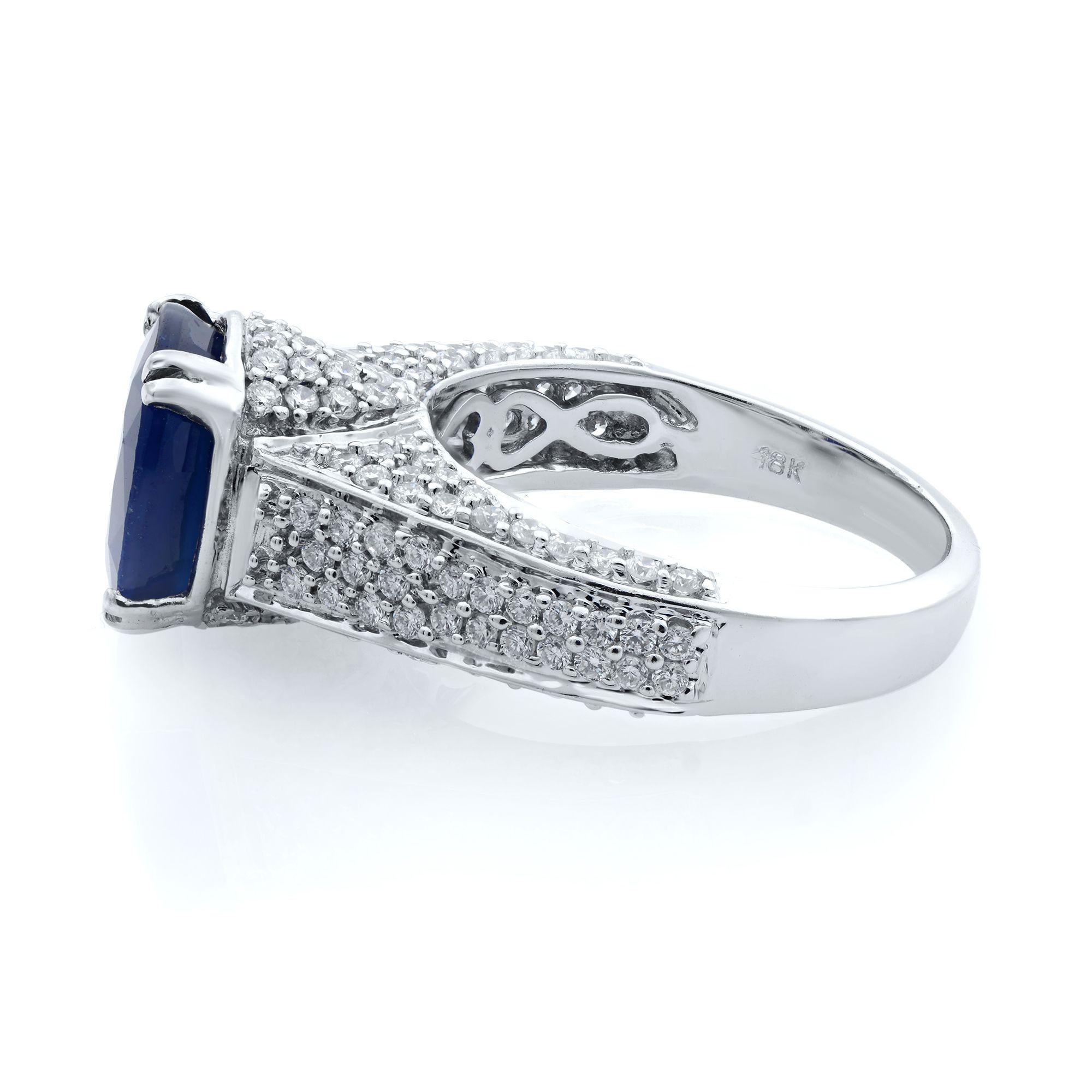 This glamorous blue oval Sapphire engagement ring secures the center gem with elegant double prongs and features pave diamonds, all over the shank. This setting style that allows light to reach the diamonds from multiple angles and enhances their