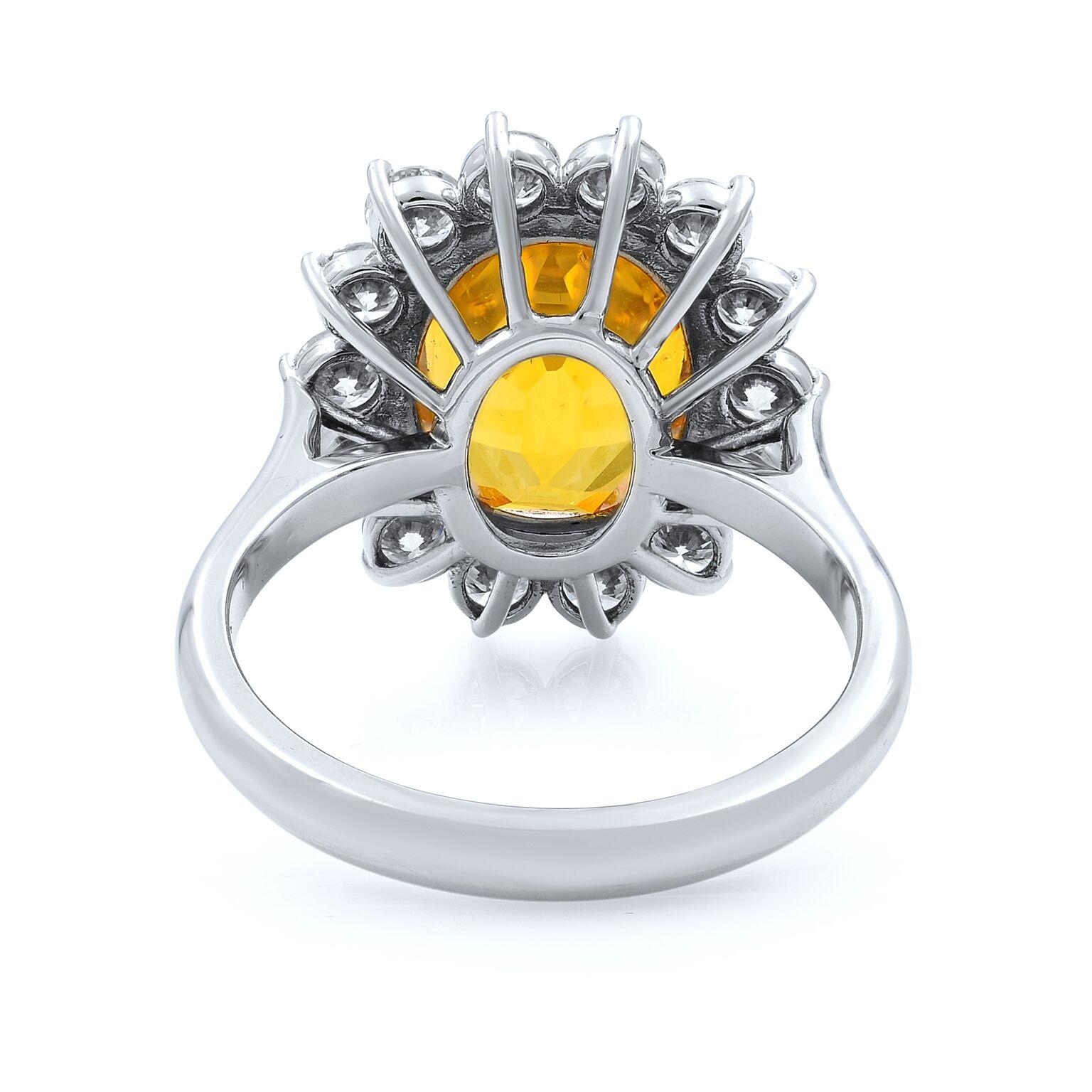 A beautiful oval yellow sapphire ring, halo set with round cut diamonds crafted in 18k white gold. Yellow sapphire weights 5.96cts. Comes with AGL certificate. Total carat weight 1.36cts. Ring Size: 7. Very classic and elegant. Presentable gift box