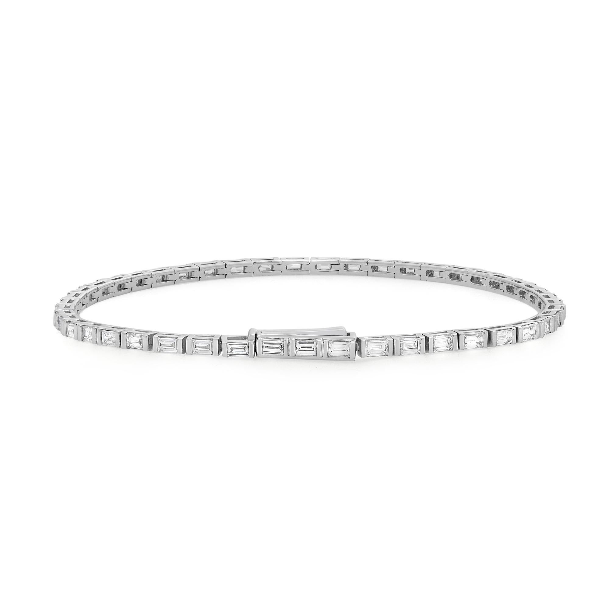 This exquisite Rachael Koen tennis bracelet features single lined baguette cut diamonds in half bezel setting style crafted in 18k white gold. Lightweight and super wearable, this handmade modern creation is a great addition to your jewelry