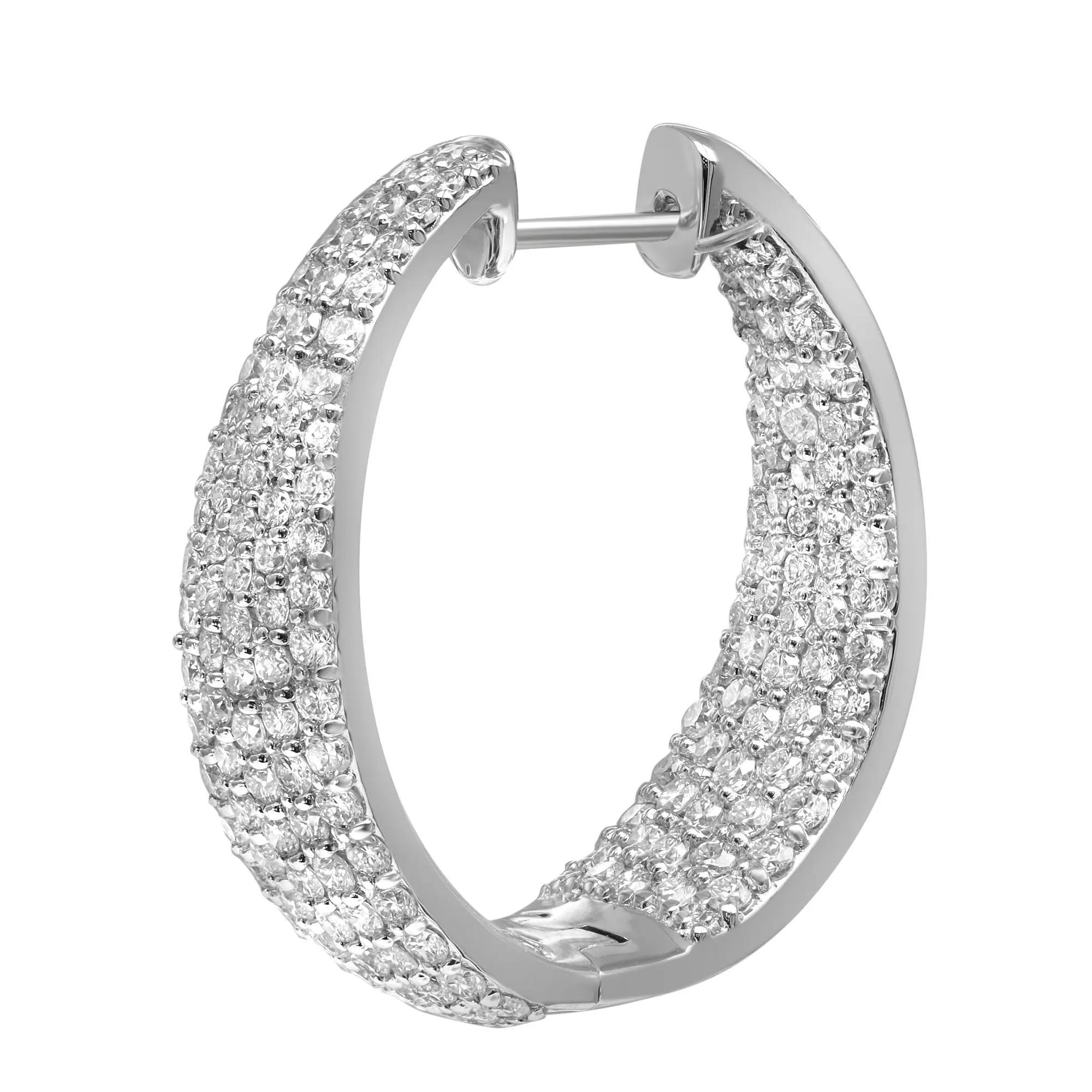 Sparkle all way with these beautiful inside out diamond hoop earrings. Crafted in fine 18K white gold. These earrings feature prong set round brilliant cut diamonds. The stones line only half of the outer hoop and half of the inner hoop. Total