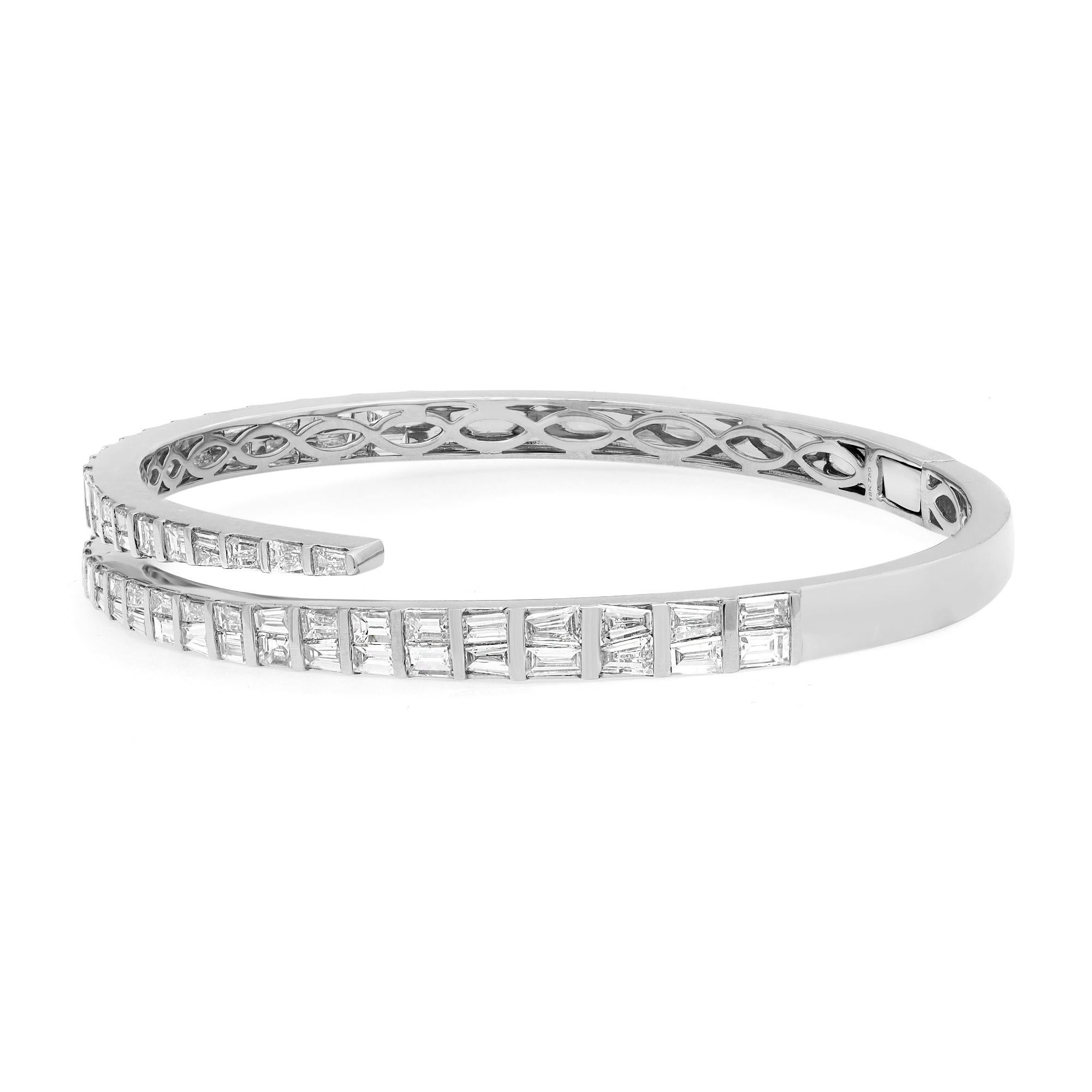 Let your style shine with this fancy and elegant diamond bangle bracelet. Crafted in 18k white gold, this stunning bracelet features 78 channel set tapered Baguette cut shimmering diamonds with a total weight of 4.27 carats. Diamond color G-H and