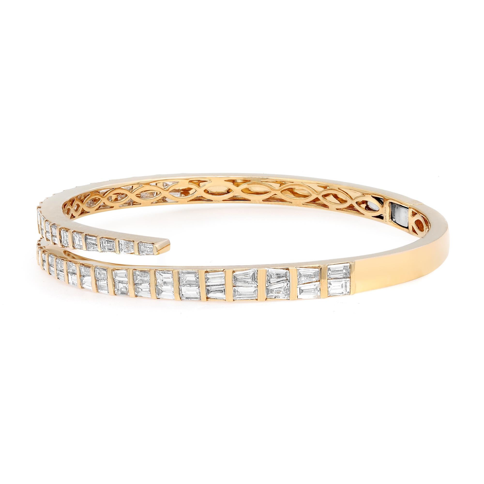 Let your style shine with this fancy and elegant diamond bangle bracelet. Crafted in 18k yellow gold. This stunning bracelet features 74 channel set tapered baguette cut shimmering diamonds with a total weight of 4.27 carats. Diamond color G-H and
