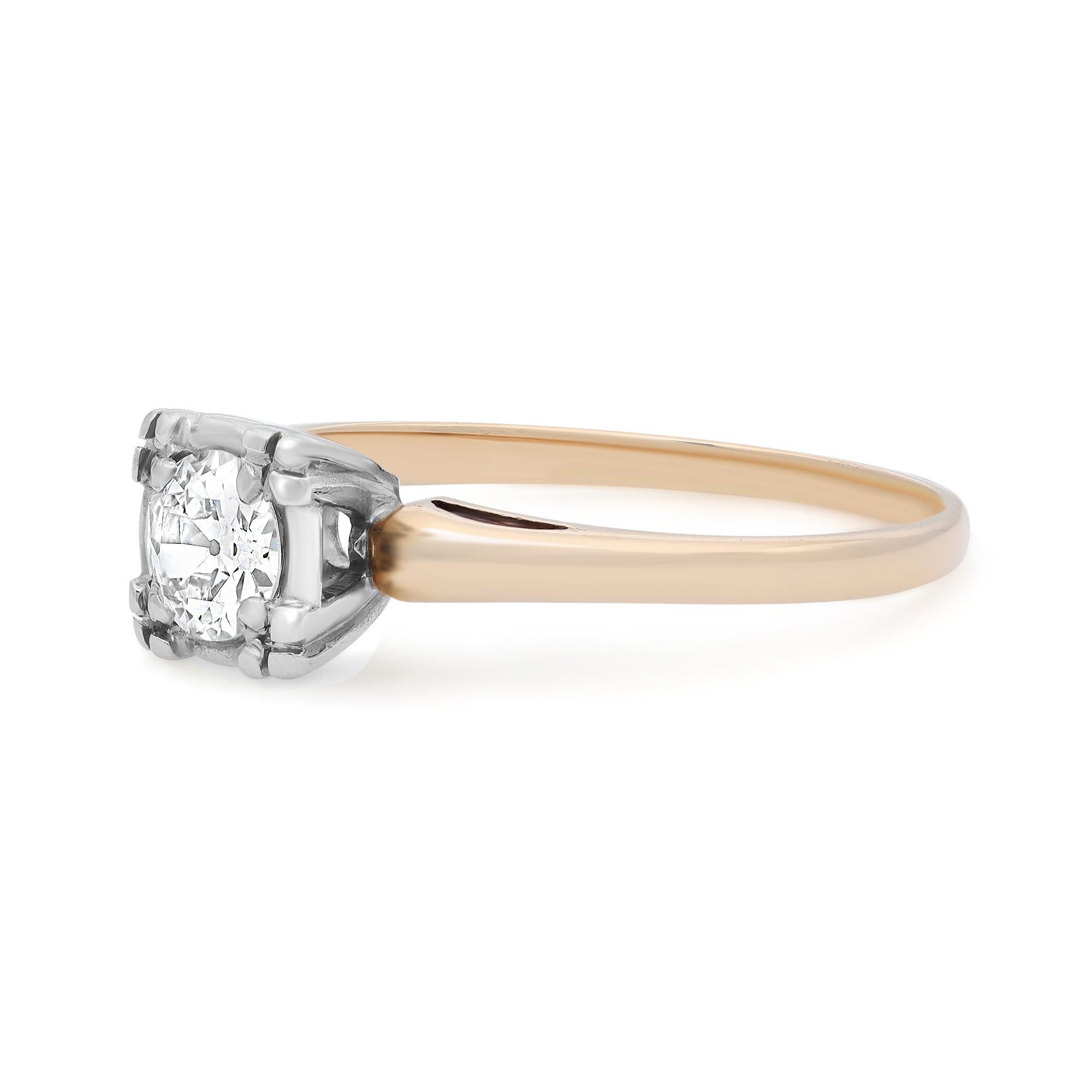 This antique solitaire engagement ring is crafted in 14K yellow gold and features a bezel set round european cut diamond weighing 0.40 carat. Diamond quality: color G-H and clarity SI1. This vintage timeless design is a perfect addition to your