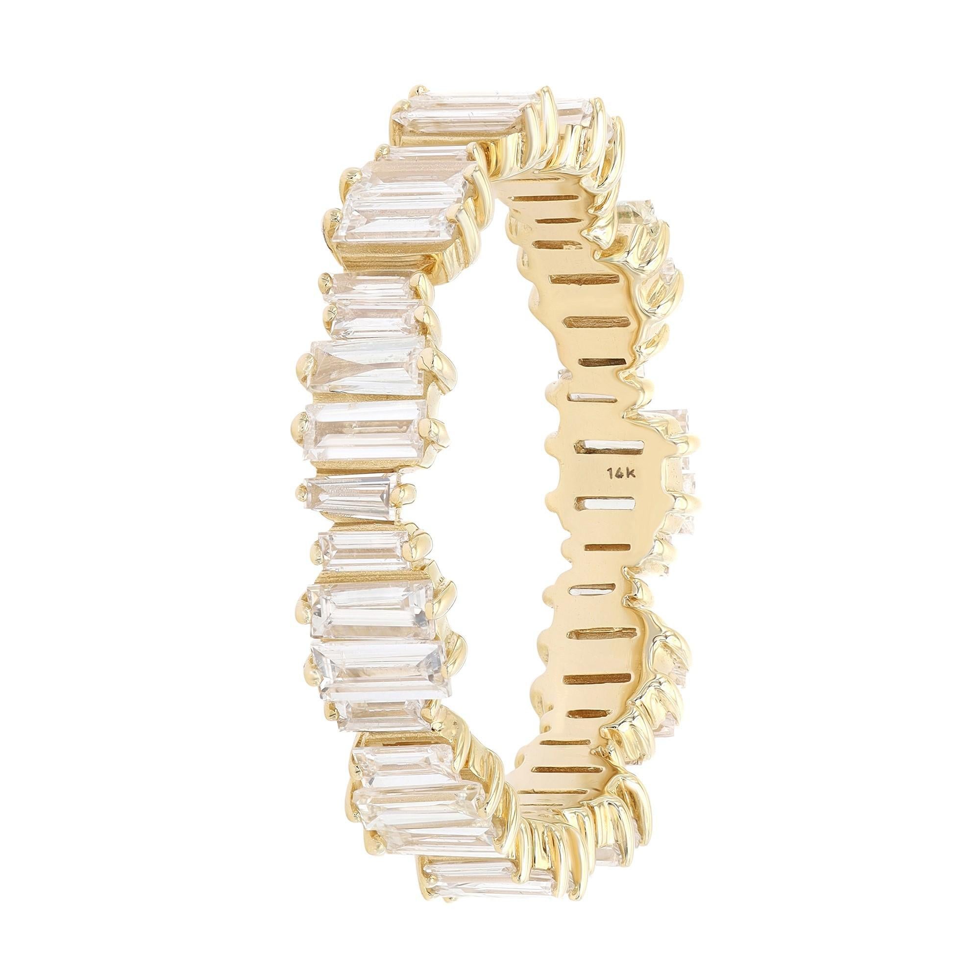 This simple and sophisticated diamond eternity band is crafted in 14k yellow gold. Features 44 prong set baguette cut diamonds set all through the ring portraying a timeless, eye-catching style. It's stackable and easy to mix and match. Diamond