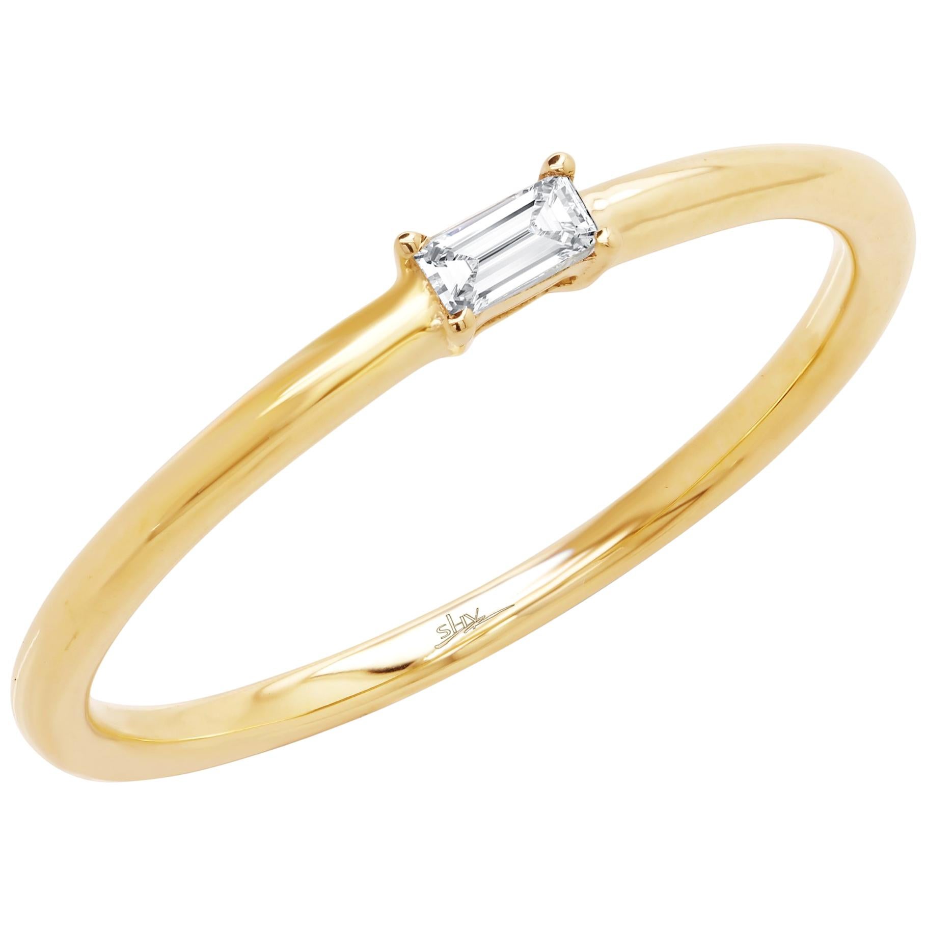 Petite and trendy, this ring is crafted in 14k yellow gold and encrusted with a baguette cut diamond weighing 0.07cttw. Height: 2.2mm. Thickness: 2.5mm. Width: 2.1mm. Ring size: 7. Total weight: 1.50 gms. Super stackable and can be mix matched.