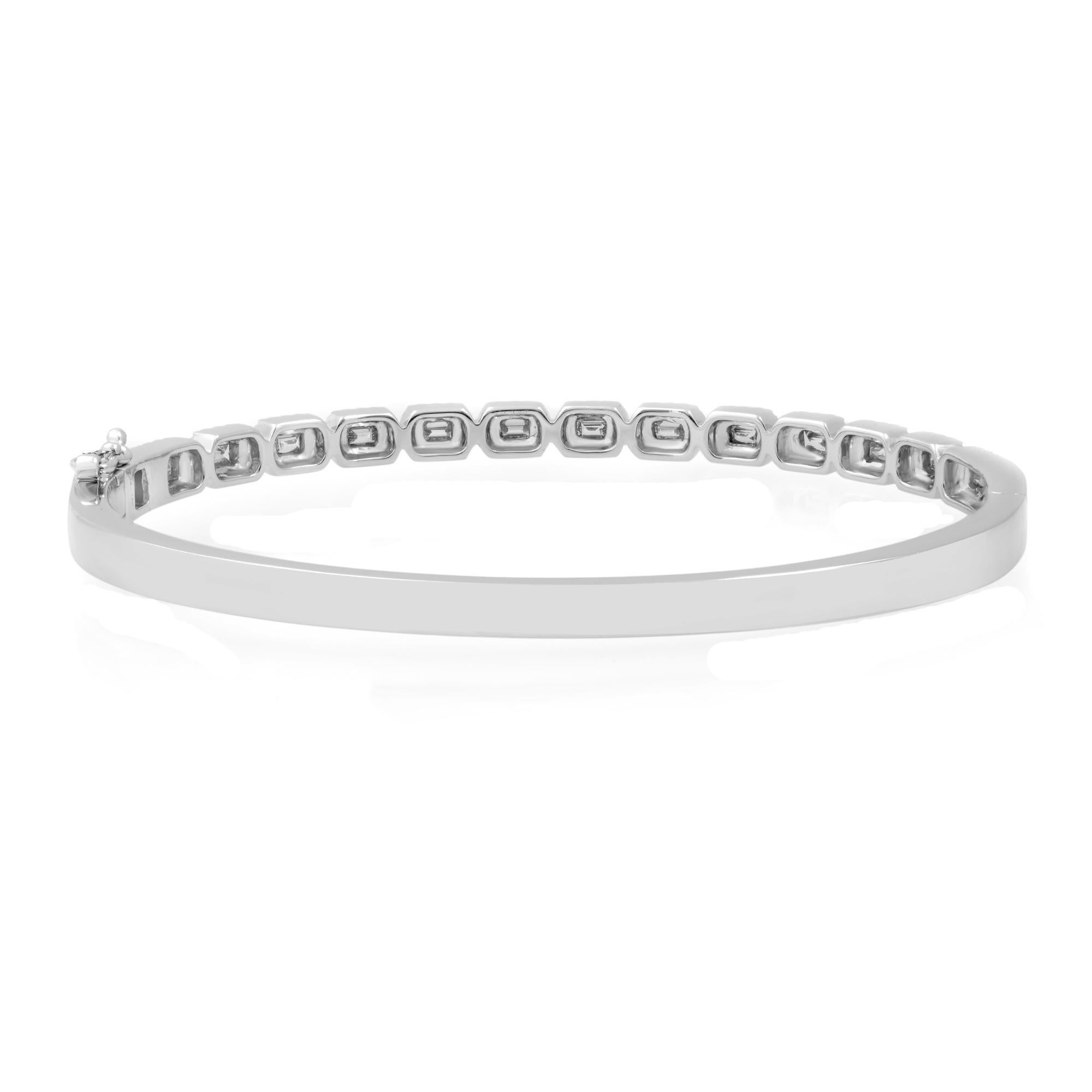 Let your style shine with this classic and elegant diamond bangle bracelet. Encrusted with bright white natural baguette cut and round cut diamonds set halfway through the bangle. Crafted in fine high polished 14k white gold. The total diamond
