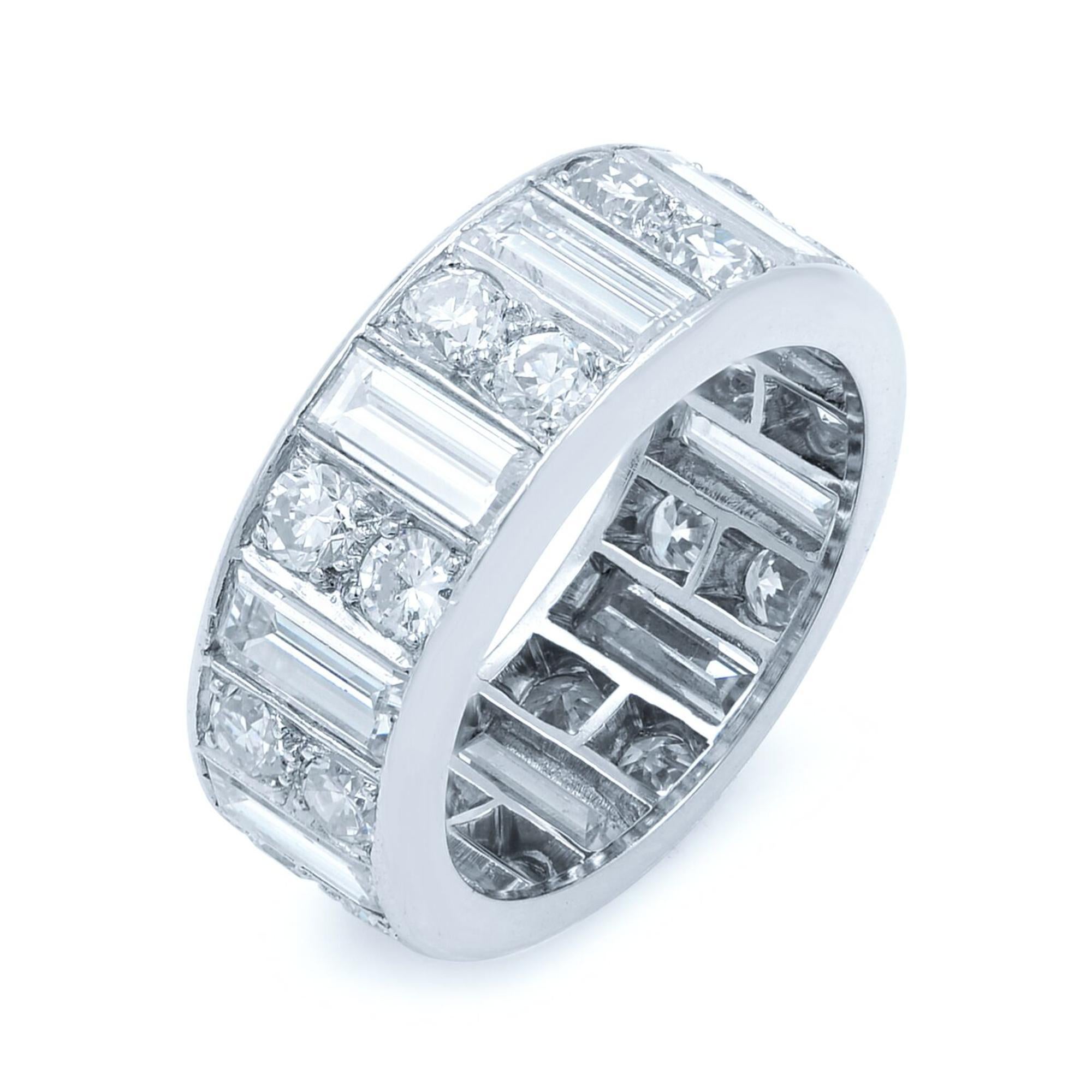 This eternity band is featuring 20 round cut diamonds totaling 1.50 carats and 10 baguette cut diamonds totaling 2.50 carats. Width of the ring is 7.35 mm and thickness is 2.40 mm. Ring size 5.75. This band is a very luxurious piece with a stunning